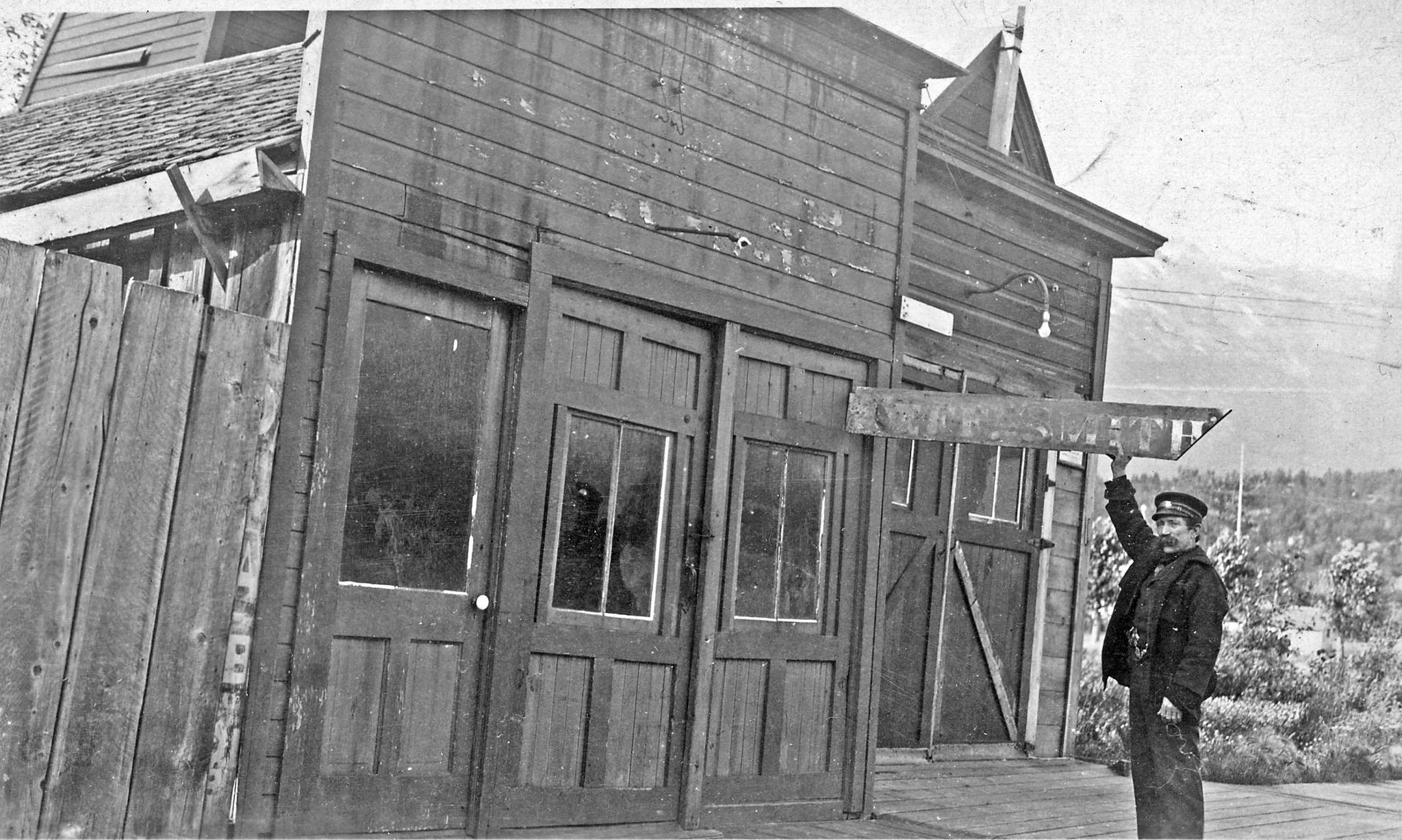 Martian Itjen stands in front of his newly acquired building and holding up Jeff Smith’s original façade sign. The date of this image is uncertain but the photograph was probably taken at the time of Itjen’s purchase of the building around 1935. (Courtesy Photo | National Park Service, Klondike Gold Rush National Historical Park, George & Edna Rapuzzi Collection, KLGO 55695, Gift of the Rasmuson Foundation)