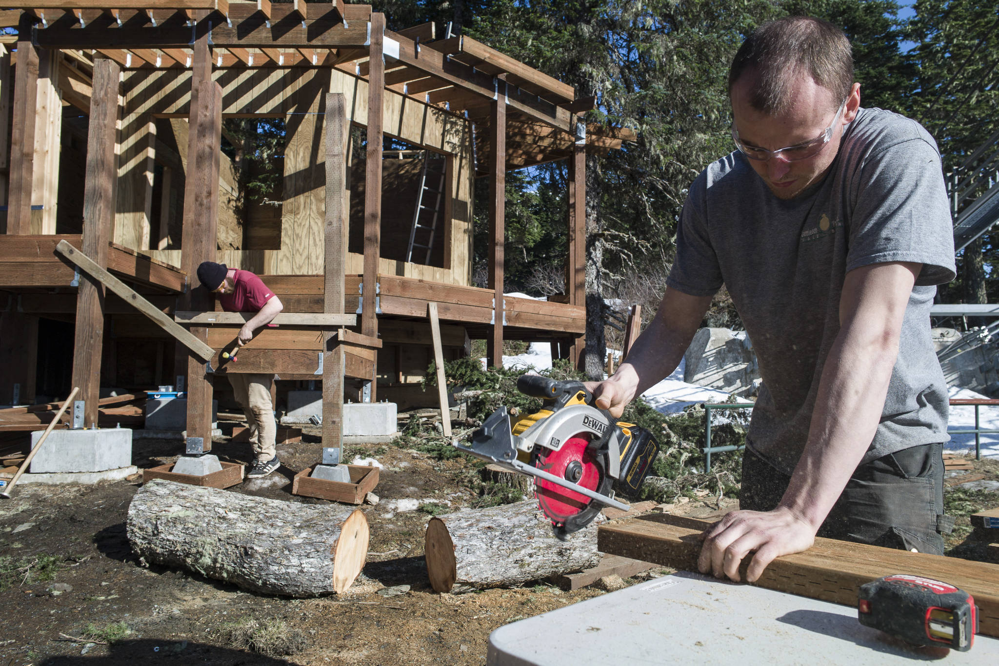 Matthew Kenkle and Joseph Staran, right, of Silverbow Construction, build a new education display for the Juneau Raptor Center on Mount Roberts on Thursday, March 28, 2019. The display will house Lady Baltimore, an adult bald eagle that is not releasable back to the wild. (Michael Penn | Juneau Empire)