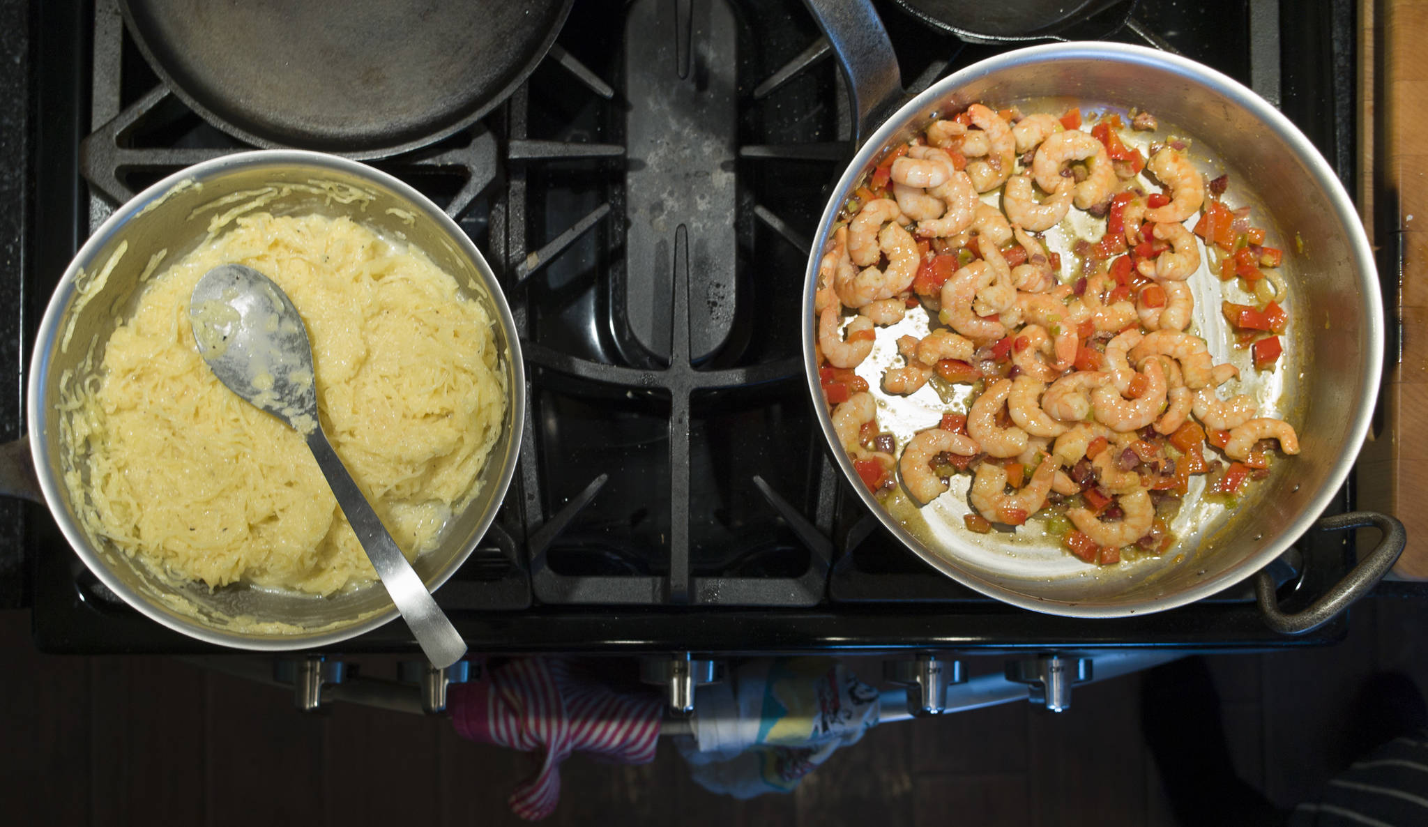 Erin Anais Heist prepares a spaghetti squash, prawns, bacon and egg breakfast dish in her home kitchen on Thursday, March 28, 2019. (Michael Penn | Juneau Empire)