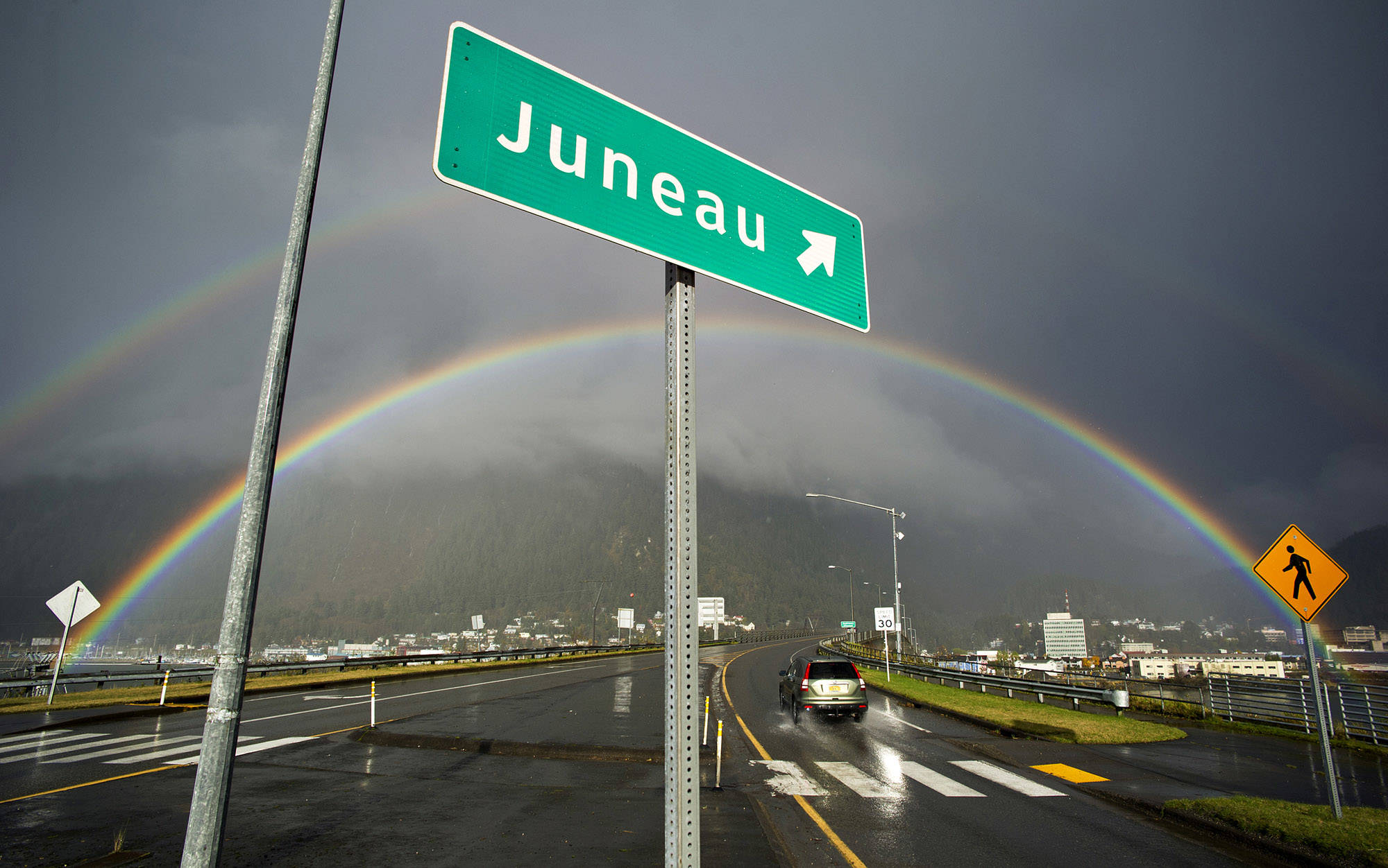 In this October 2015 photo, a momentary dash of sun creates a double rainbow over downtown Juneau. (Michael Penn | Juneau Empire File)