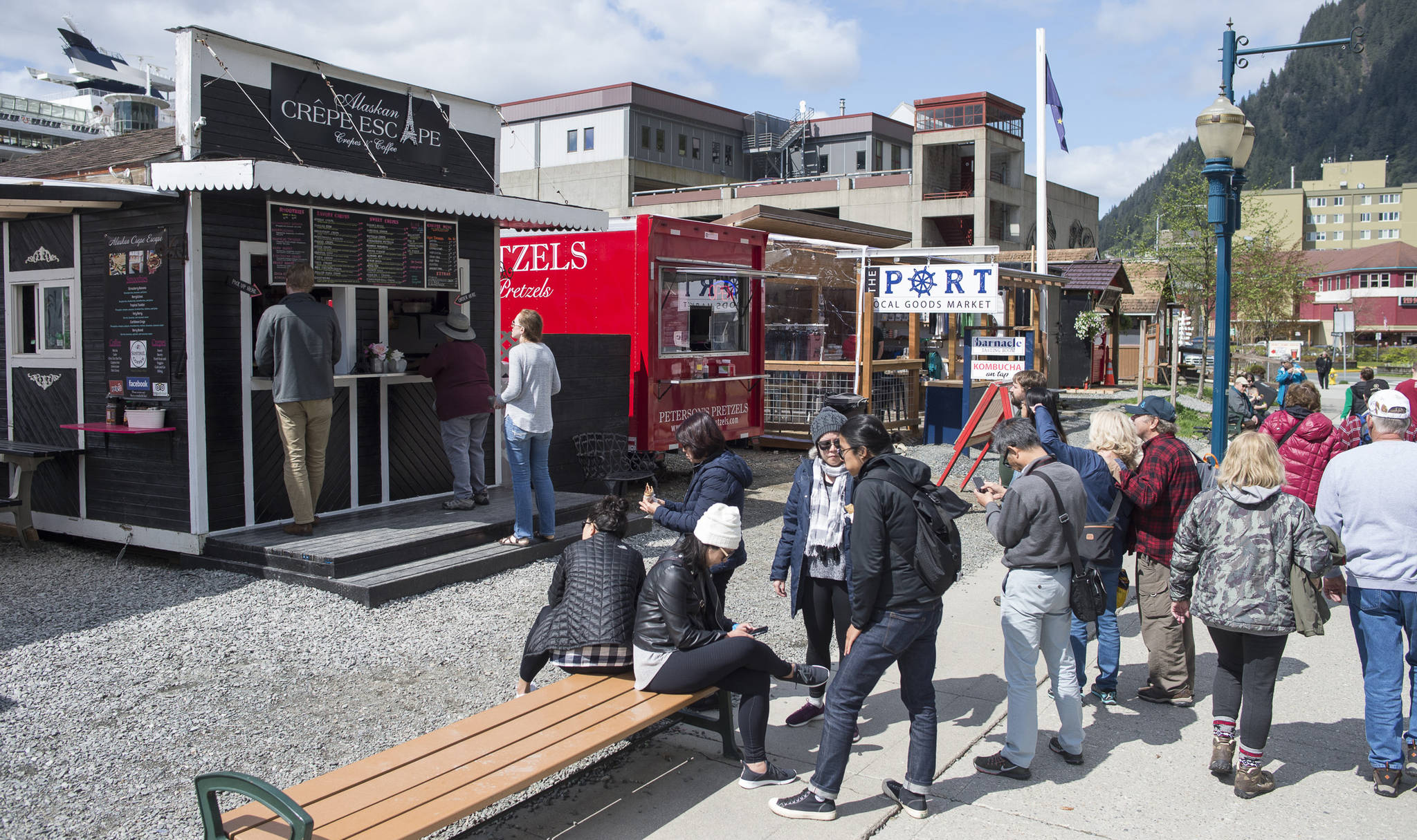 In this May 15, 2018 photo, locals and visitors visit the food trucks along South Franklin Street. (Michael Penn | Juneau Empire File)
