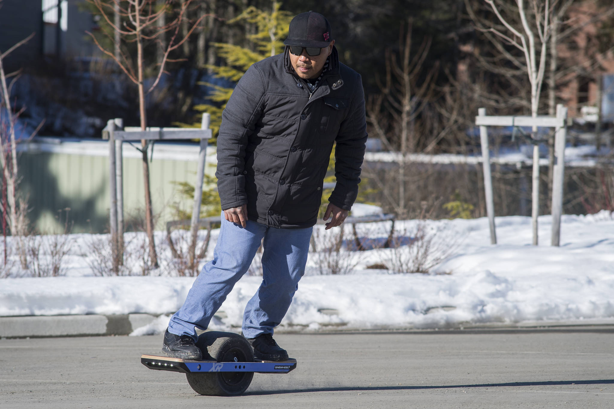 Emery Banua practices riding his Onewheel+ XR electric board in the Auke Bay Harbor parking lot on Tuesday, March 5, 2019. Banua said he just received the device that rides like a skateboard but can also go uphill and has a 12 to 18 mile range. (Michael Penn | Juneau Empire)