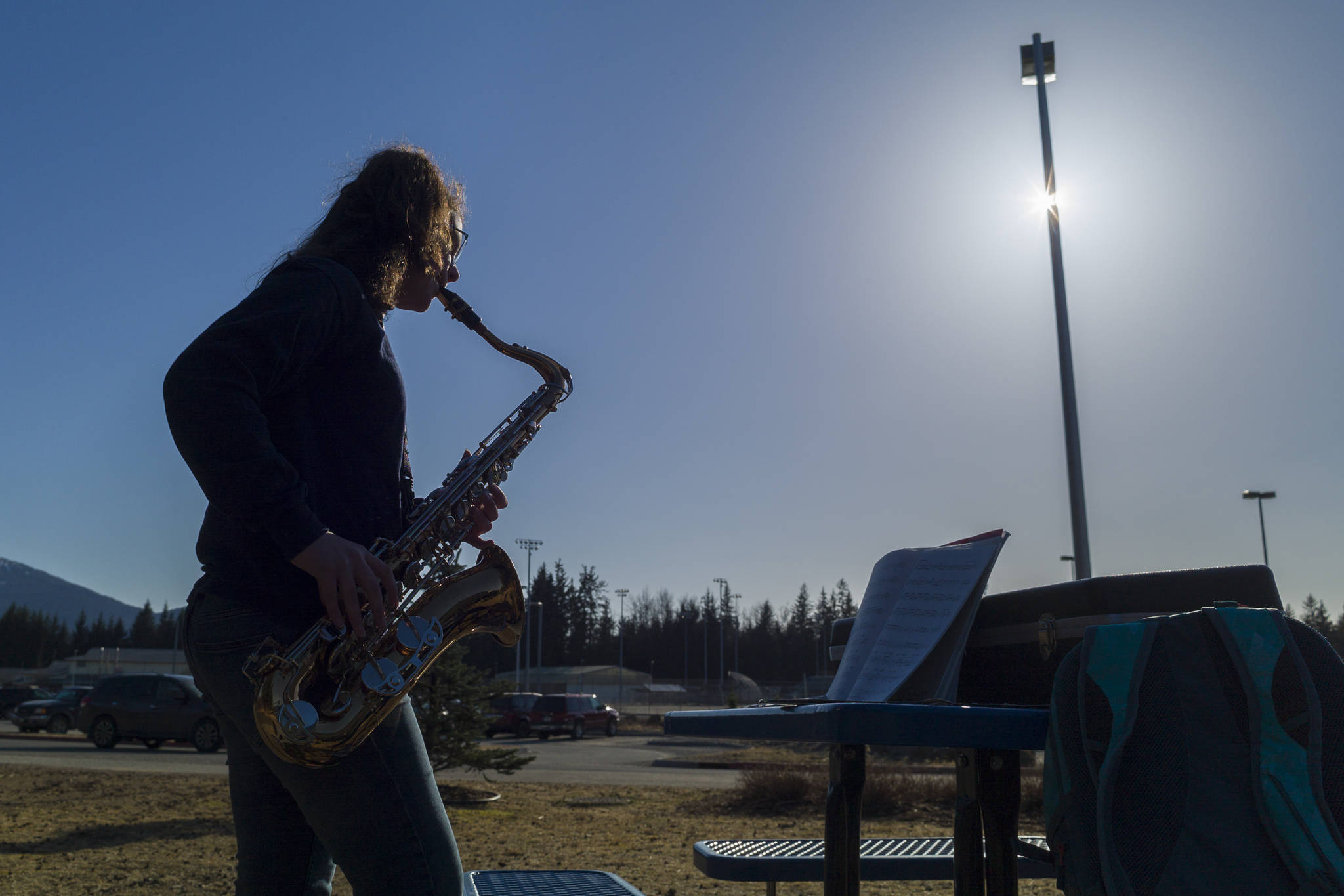 Seveth-grader Allisyn Frazier practices her tenor saxophone outside of the Dimond Park Aquatic Center on Friday, March 29, 2019. (Michael Penn | Juneau Empire)