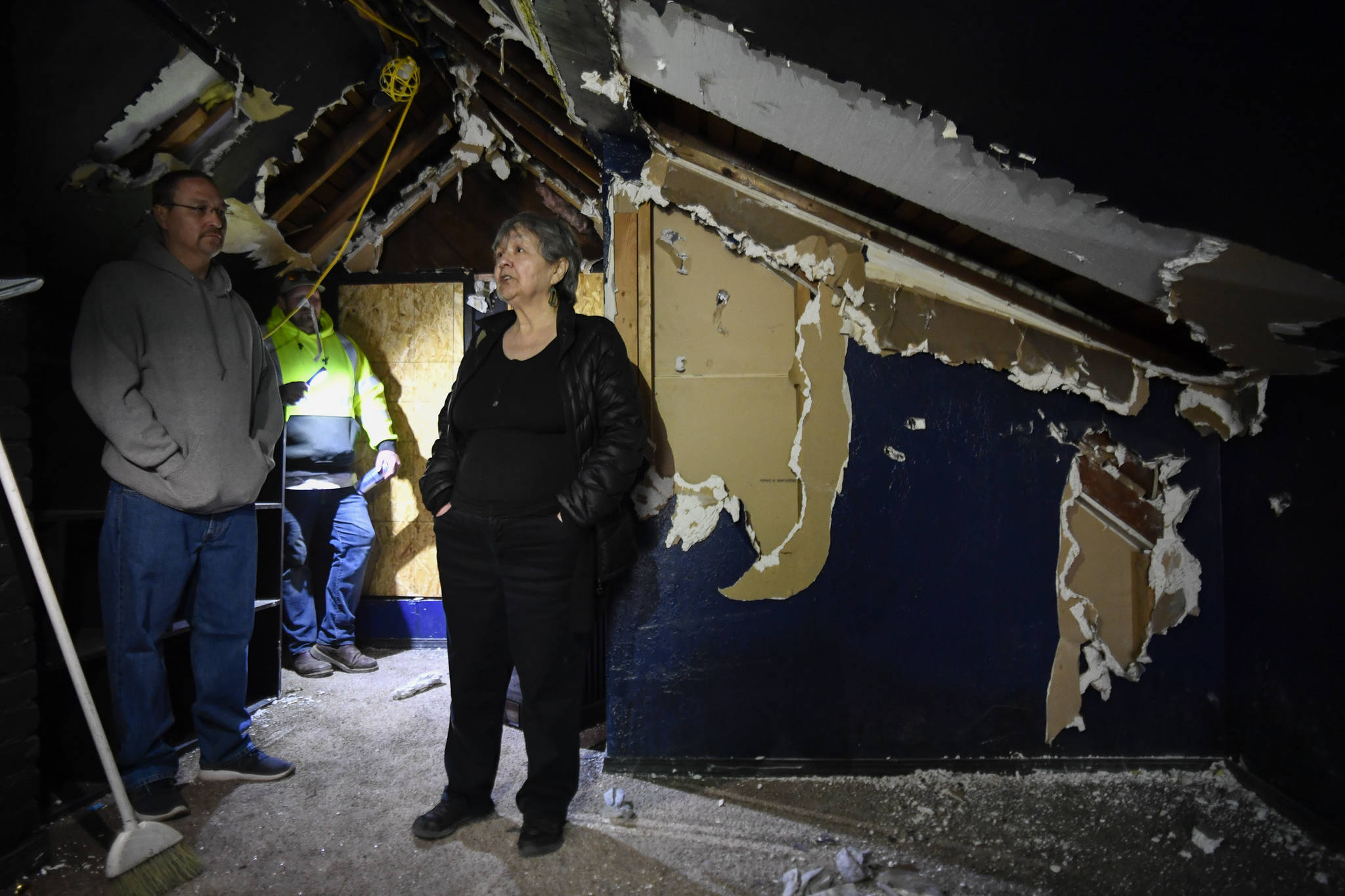 Ernestine Hayes, with her son, Joshua Stephenson, left, and contractor Derik Wythe gives a tour of her fire-damaged house at the corner of 5th and Franklin Street on Wednesday, April 3, 2019. (Michael Penn | Juneau Empire)