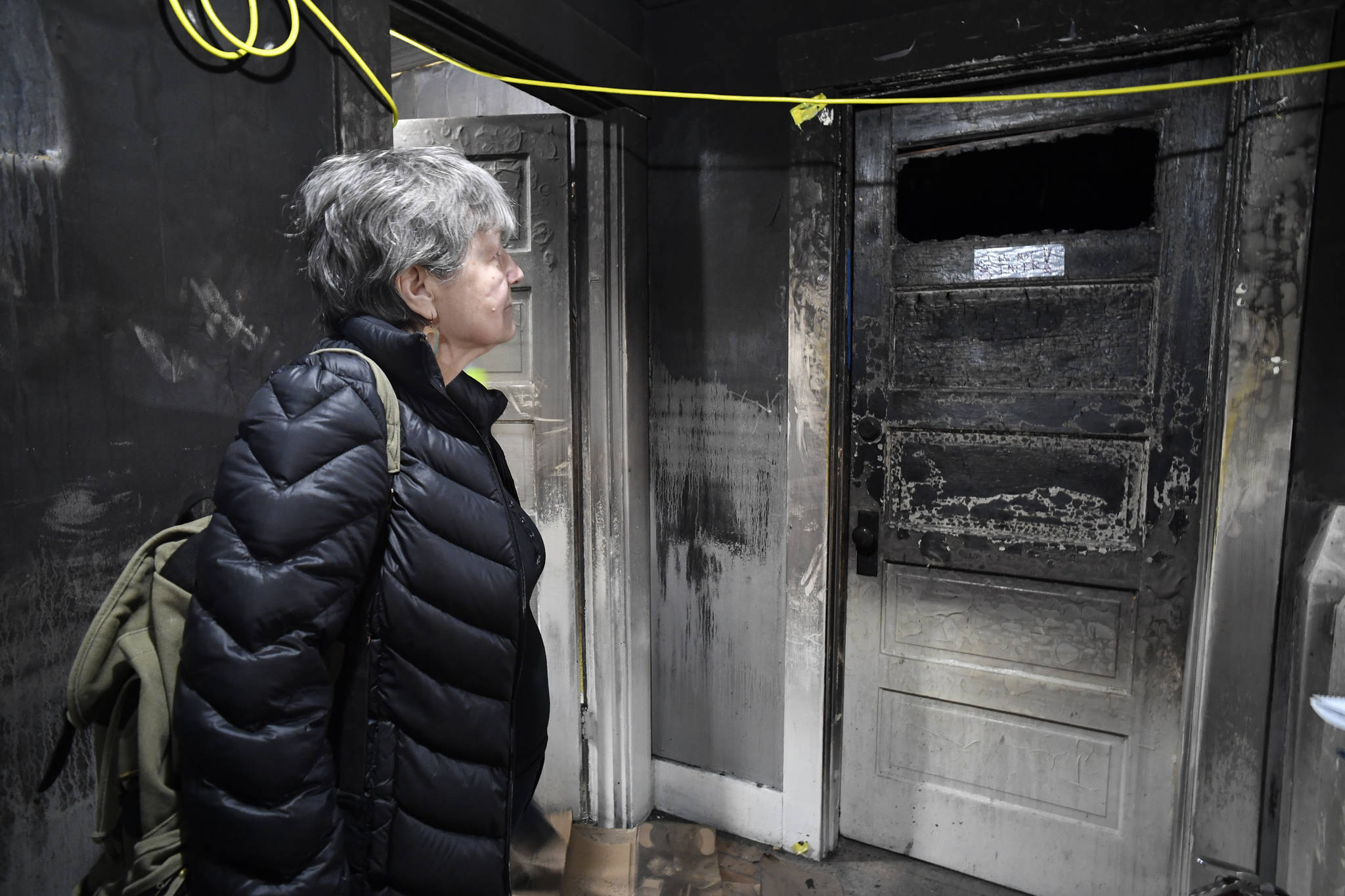 Ernestine Hayes gives a tour of her fire-damaged house at the corner of 5th and Franklin Street on Wednesday, April 3, 2019. (Michael Penn | Juneau Empire)