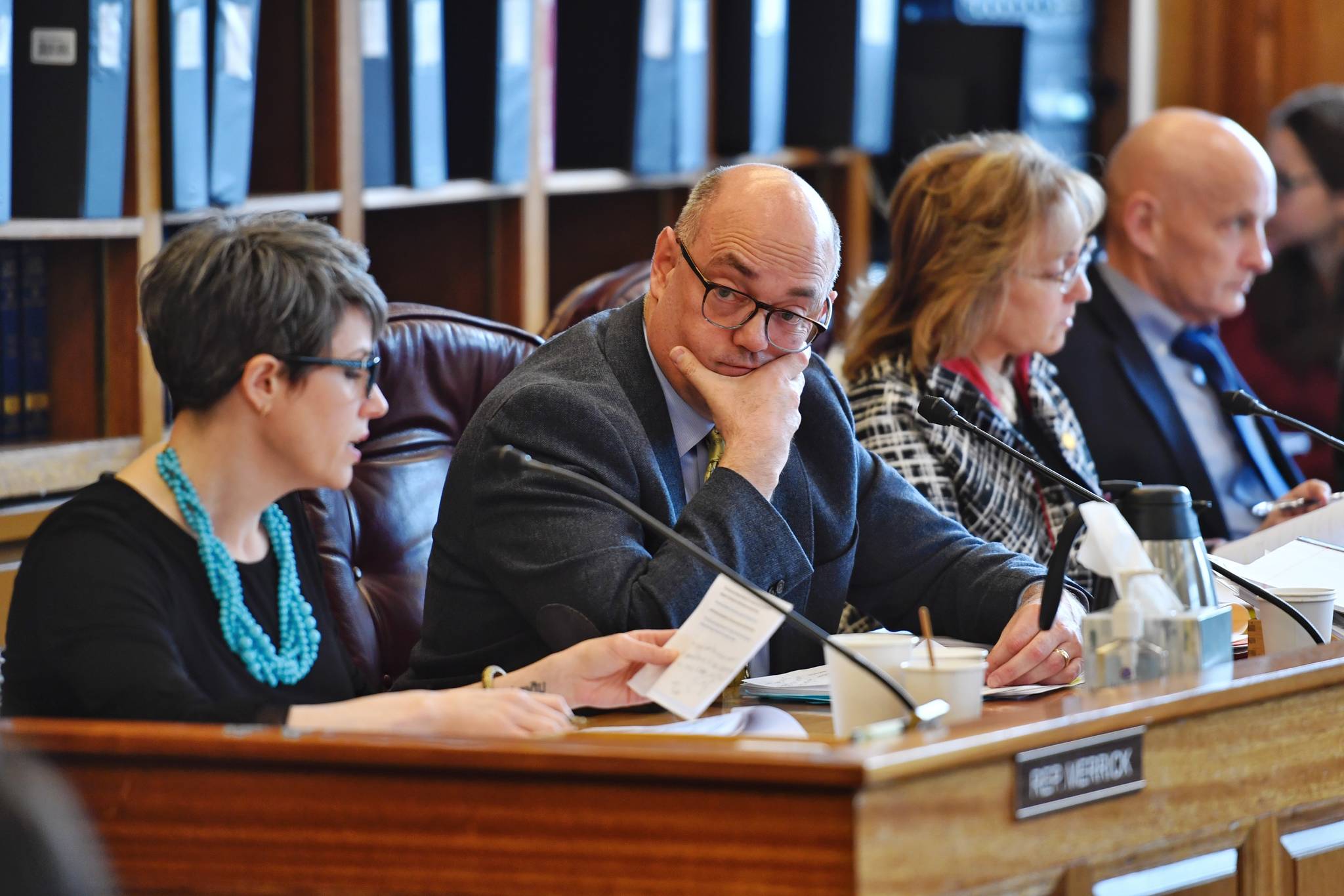 Rep. Andy Josephson, D-Anchorage, second from left, listens to Rep. Kelly Merrick, R-Eagle River, as she reads an amendment to repeal the Ocean Ranger program during a House Finance Committee meeting at the Capitol on Thursday, April 4, 2019. The Ocean Ranger program was approved through a voter ballot initiative in 2006. The amendment passed 8-3. (Michael Penn | Juneau Empire)