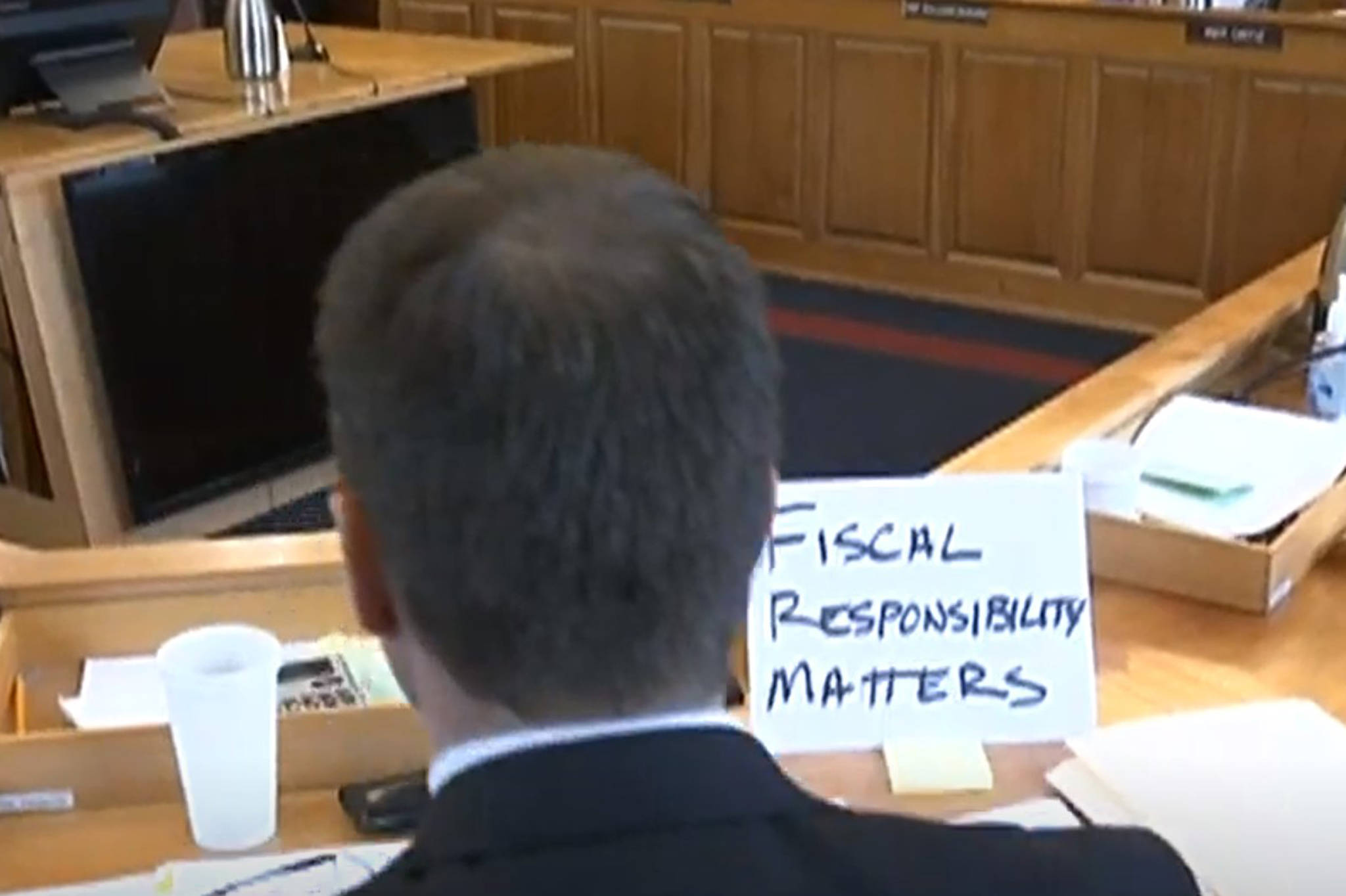 Rep. Dan Carpenter, R-Nikiski, sits at a House Finance Committee meeting on Thursday with a sign that says, “fiscal responsibility matters.” (Courtesy photo | Gavel Alaska screenshot)
