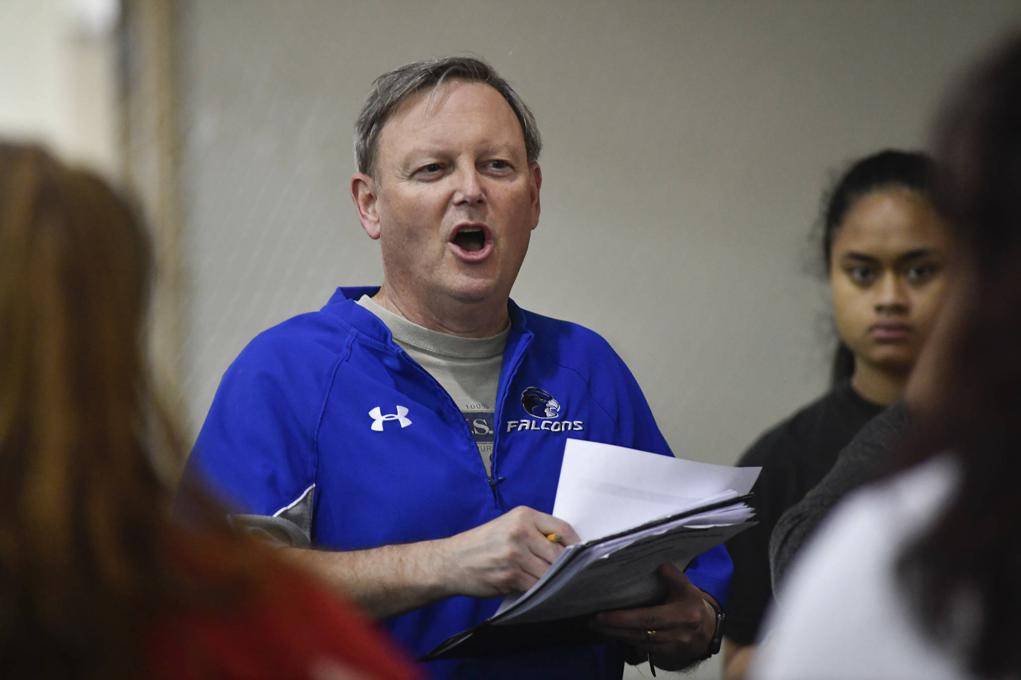 Coach John Boucher speaks to his players during Thunder Mountain High School softball practice at the Wells Fargo Dimond Park Field House on Tuesday, April 2, 2019. (Michael Penn | Juneau Empire)