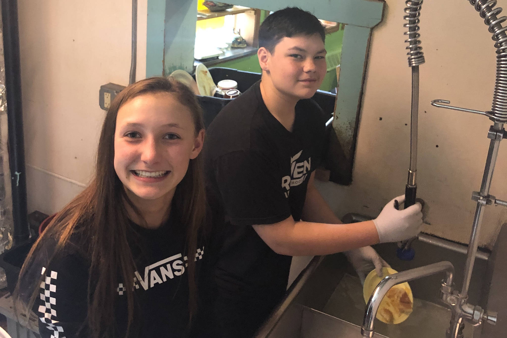 MJ Tupou and Hali Smith get involved in their community by washing dishes at the Glory Hall. (Courtesy Photo)