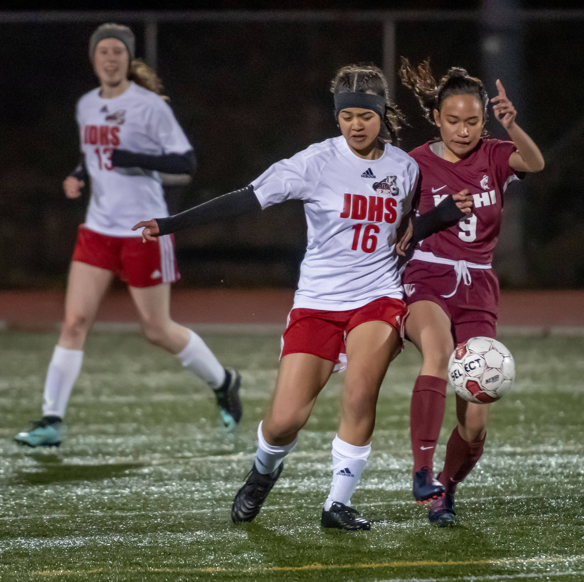 Juneau-Douglas High School’s Sophia Pugh battles for the ball against Ketchikan High School’s Ruvelen Correa during the second half of the Crimson Bears’ 5-0 win at Esther Shea Field in Ketchikan on Friday. (Charley Starr | Ketchikan Daily News)