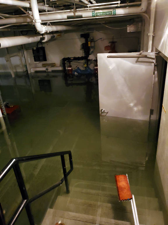 This photo shows flooding in the basement of the Marie Drake building on Friday, April 5, 2019. Flooding in a basement boiler room spread diesel fumes throughout the building. (Courtesy Photo | Chris Cairns)