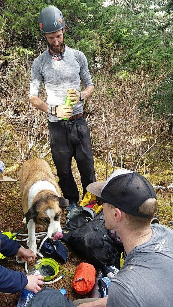 Starr Parmley, standing, and Zachary Rhoades are pictured with a dog they helped rescue from a cliff near Perseverance Trail on Wednesday. (Courtesy Photo | Zachary Rhoades)