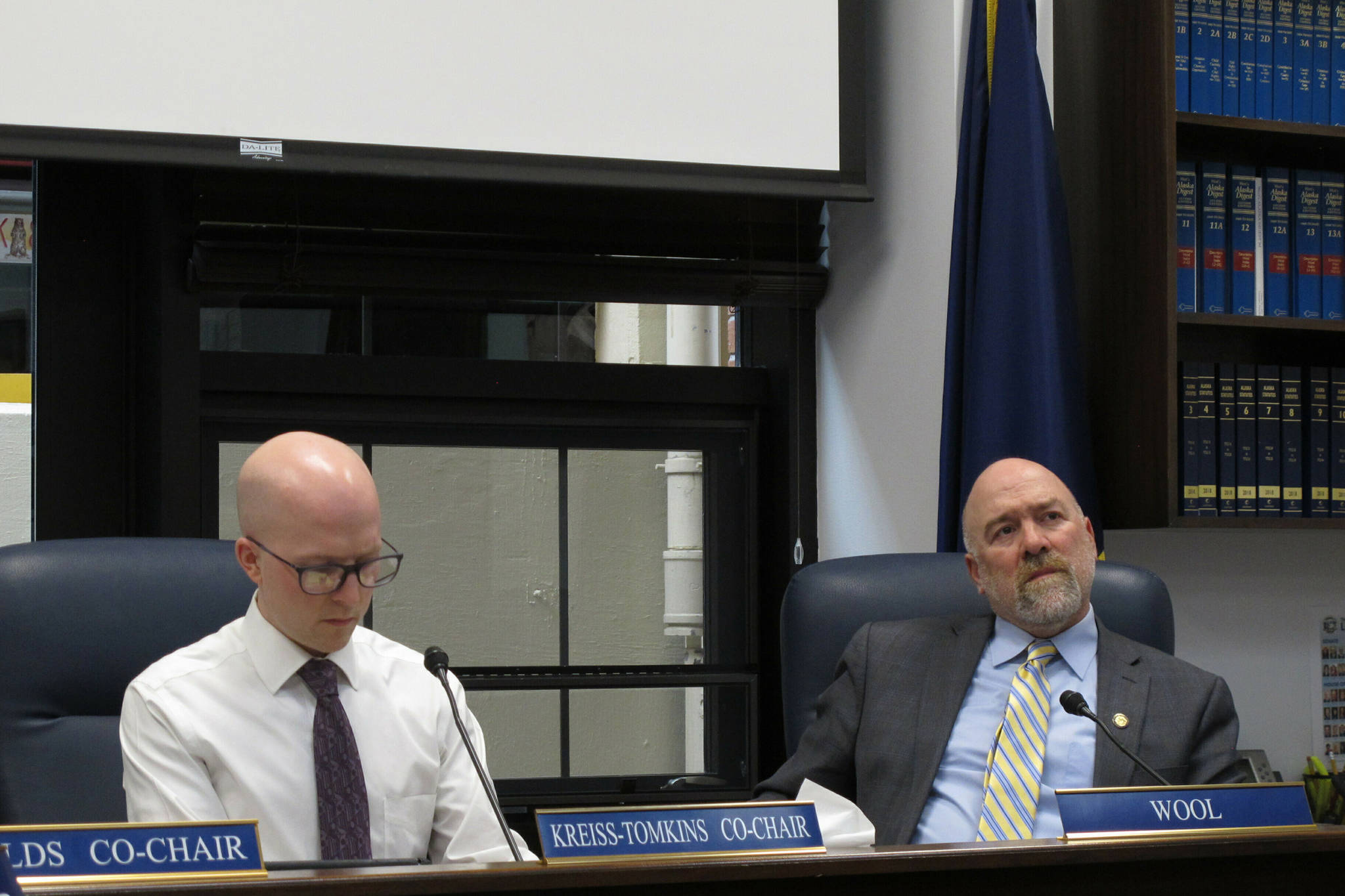 Alaska state Rep. Adam Wool, right, listens to testimony given by phone on the nomination of Amanda Price to be state Public Safety commissioner on Thursday, April 11, 2019, in Juneau, Alaska. Also shown is Rep. Jonathan Kreiss-Tomkins. (Becky Bohrer | The Associated Press)
