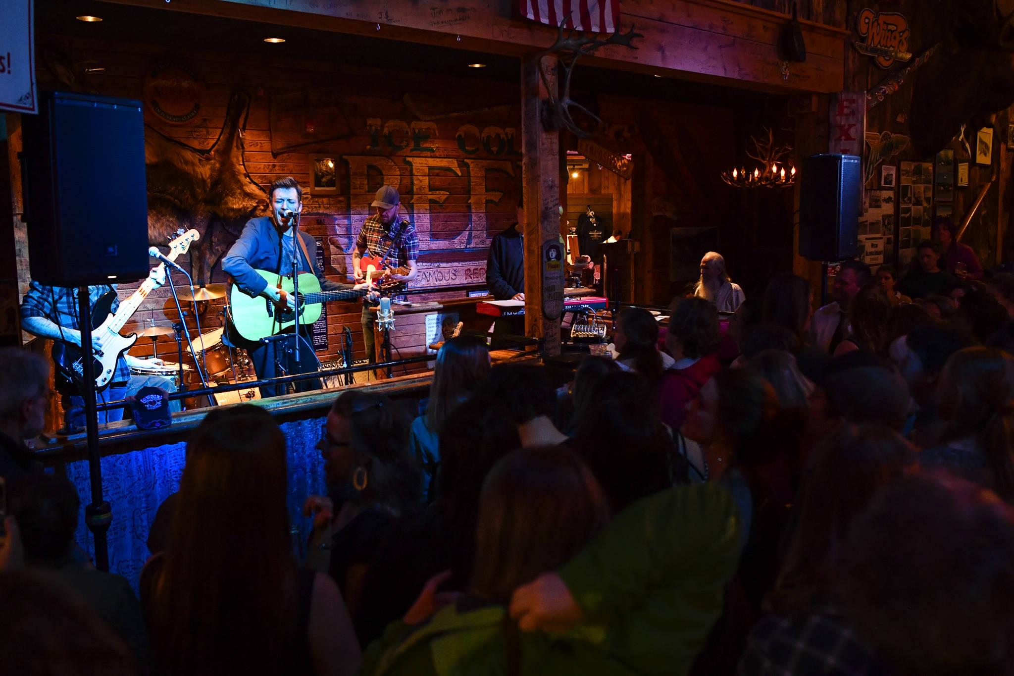 Bar patrons and music lovers listen to Juneau songwriter Dan Kirkwood and his band, Goldwing, at the Red Dog Saloon during Alaska Folk Festival week on Friday, April 12, 2019. (Michael Penn | Juneau Empire)
