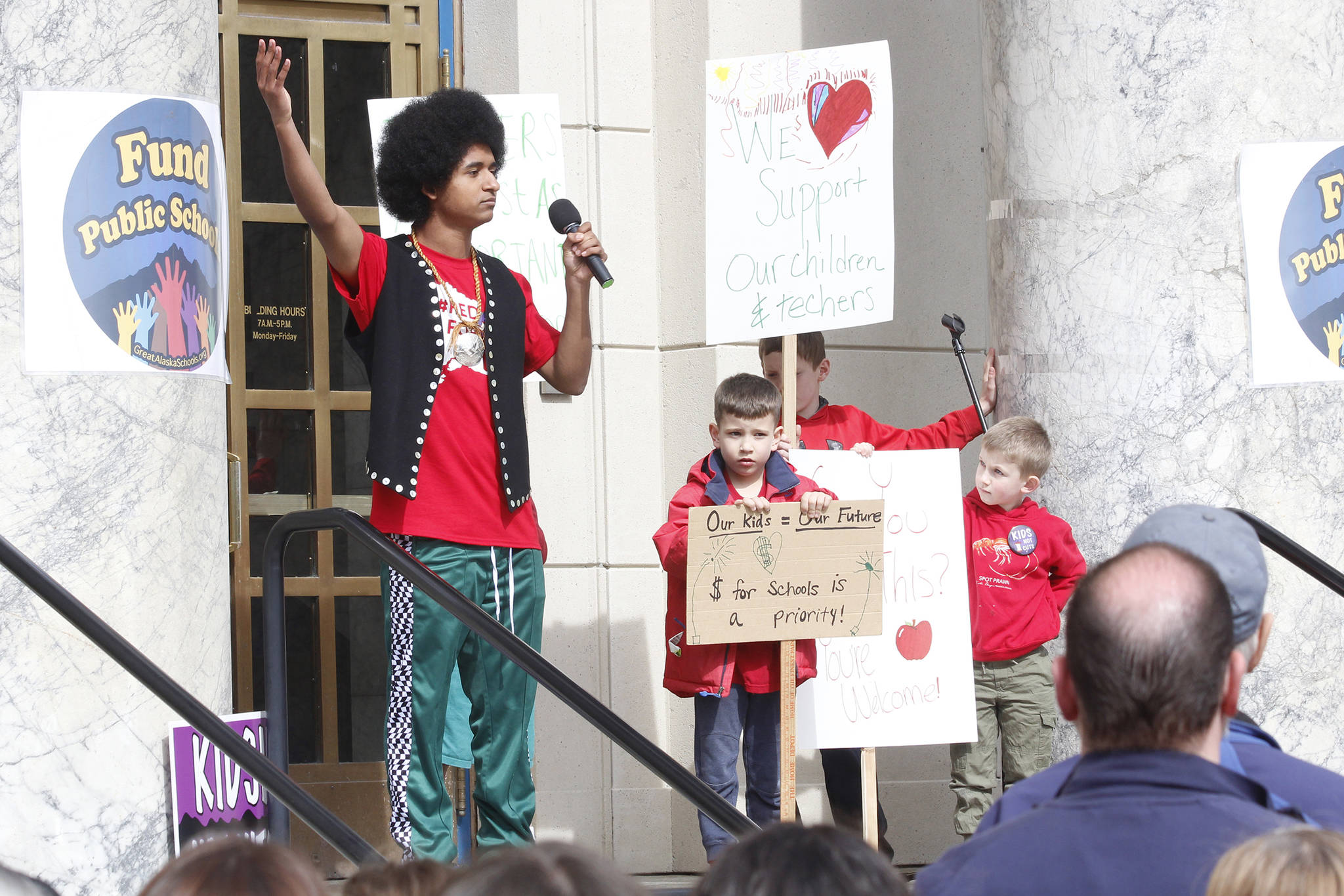Juneau-Douglas High School senior Arias Hoyle speaks at the Fund Our Future rally on the steps of the Alaska State Capitol on Saturday. (Alex McCarthy | Juneau Empire)