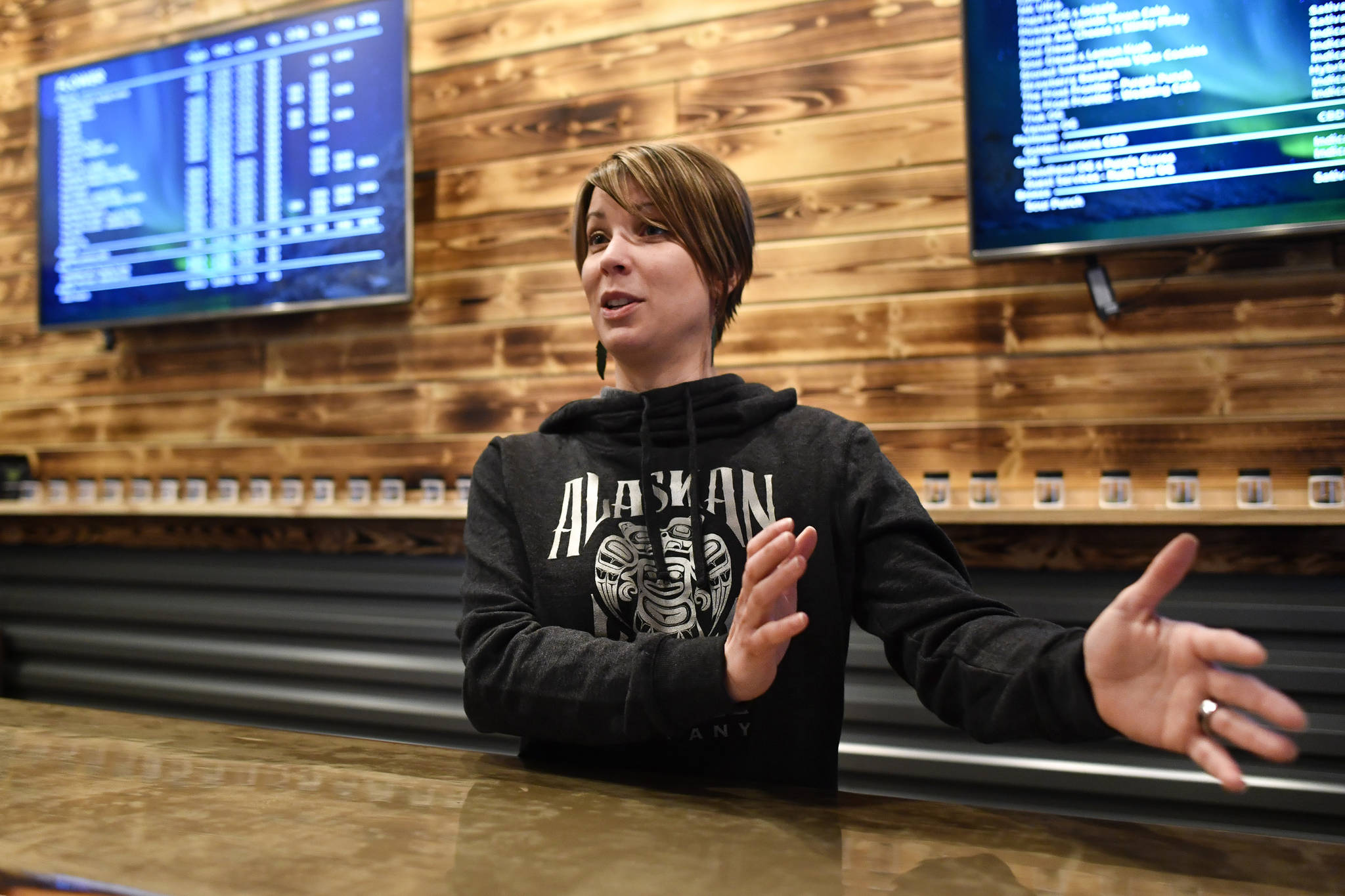 Amy Herrick, manager at the Alaskan Kush Company downtown retail store, talks about the possibility of opening an onsite consumption space on Tuesday, April 16, 2019. (Michael Penn | Juneau Empire)