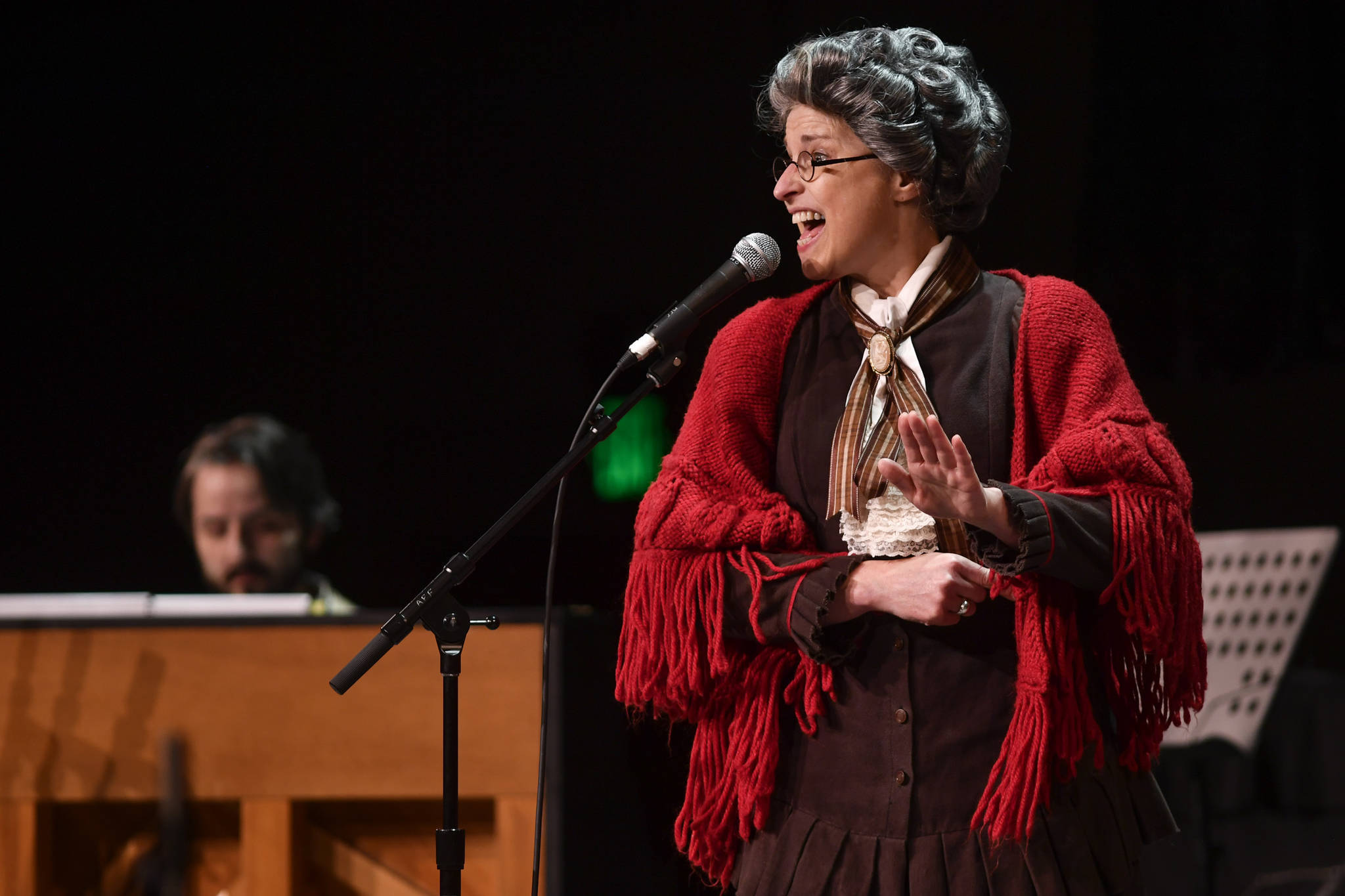 Patricia Hull, of Juneau, accompanied by Jon Hays, performs as “The Most Dangerous Woman in America” at the 45th annual Alaska Folk Festival at Centennial Hall on Monday, April 8, 2019. (Michael Penn | Juneau Empire)