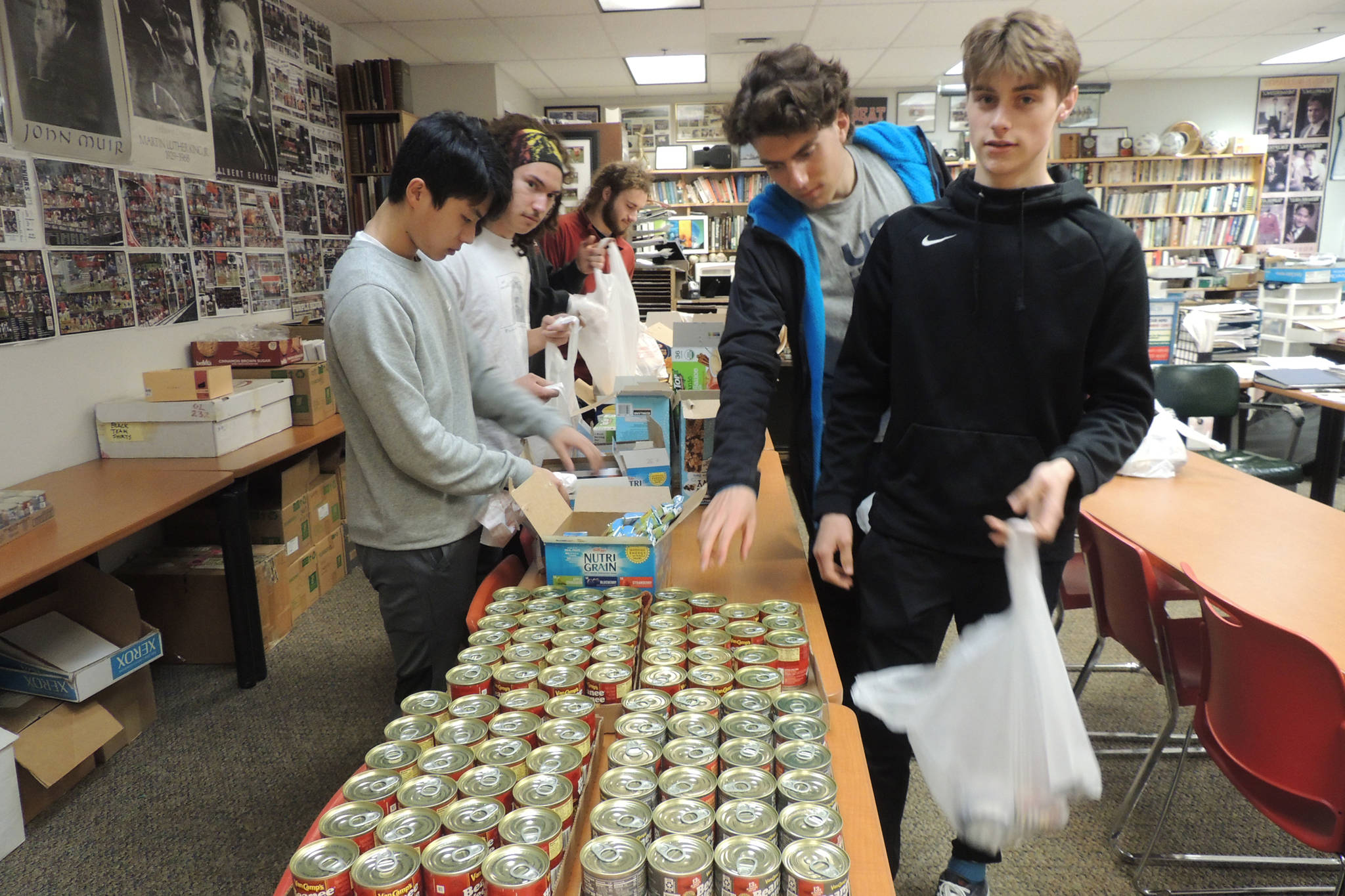 Members of the Juneau-Douglas High School: Yadaa.at Kalé boys soccer team fill bags with food for the Backpack Lunch Program. (Courtesy Photo)
