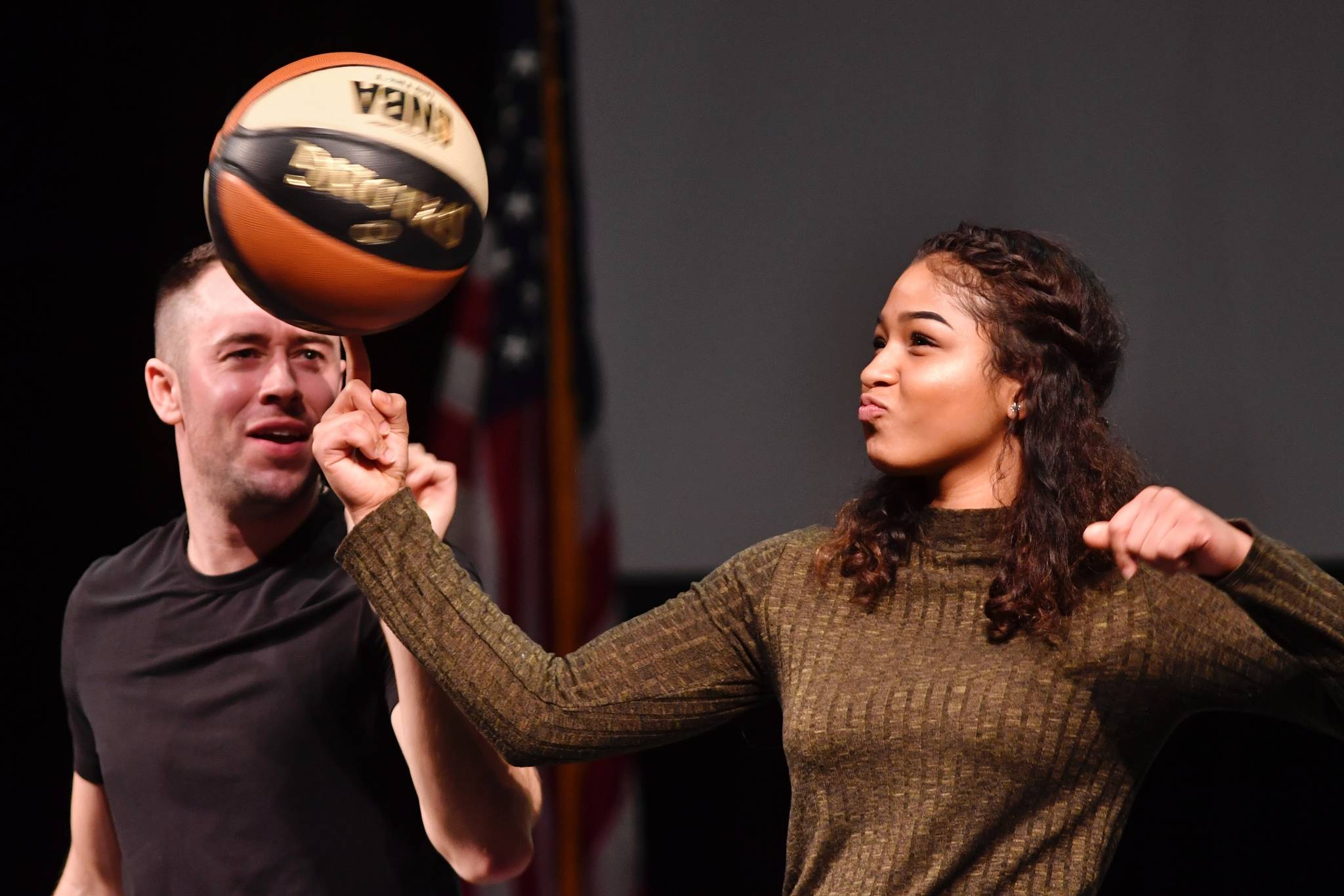 Jesse LeBeau, left, helps Destiny Cleveland, 17, spin a basketball during his Pillars of America speech at Centennial Hall on Wednesday, April 17, 2019. (Michael Penn | Juneau Empire)
