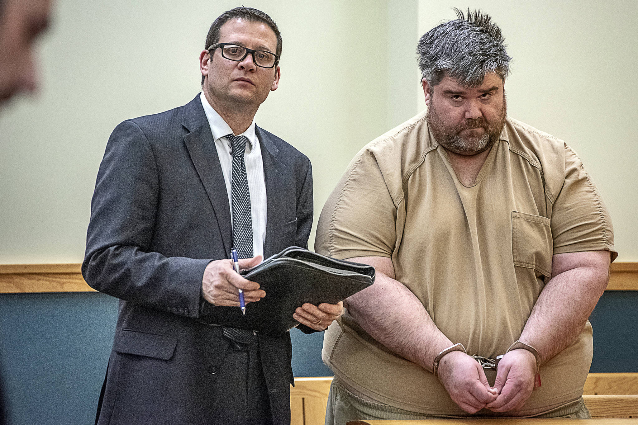 In this Feb. 19, 2019 photo, Steven Downs, 44, of Auburn, Maine, right, stands for his initial appearance in 8th District Court in Lewiston, Maine. (Andree Kehn | Sun Journal File)