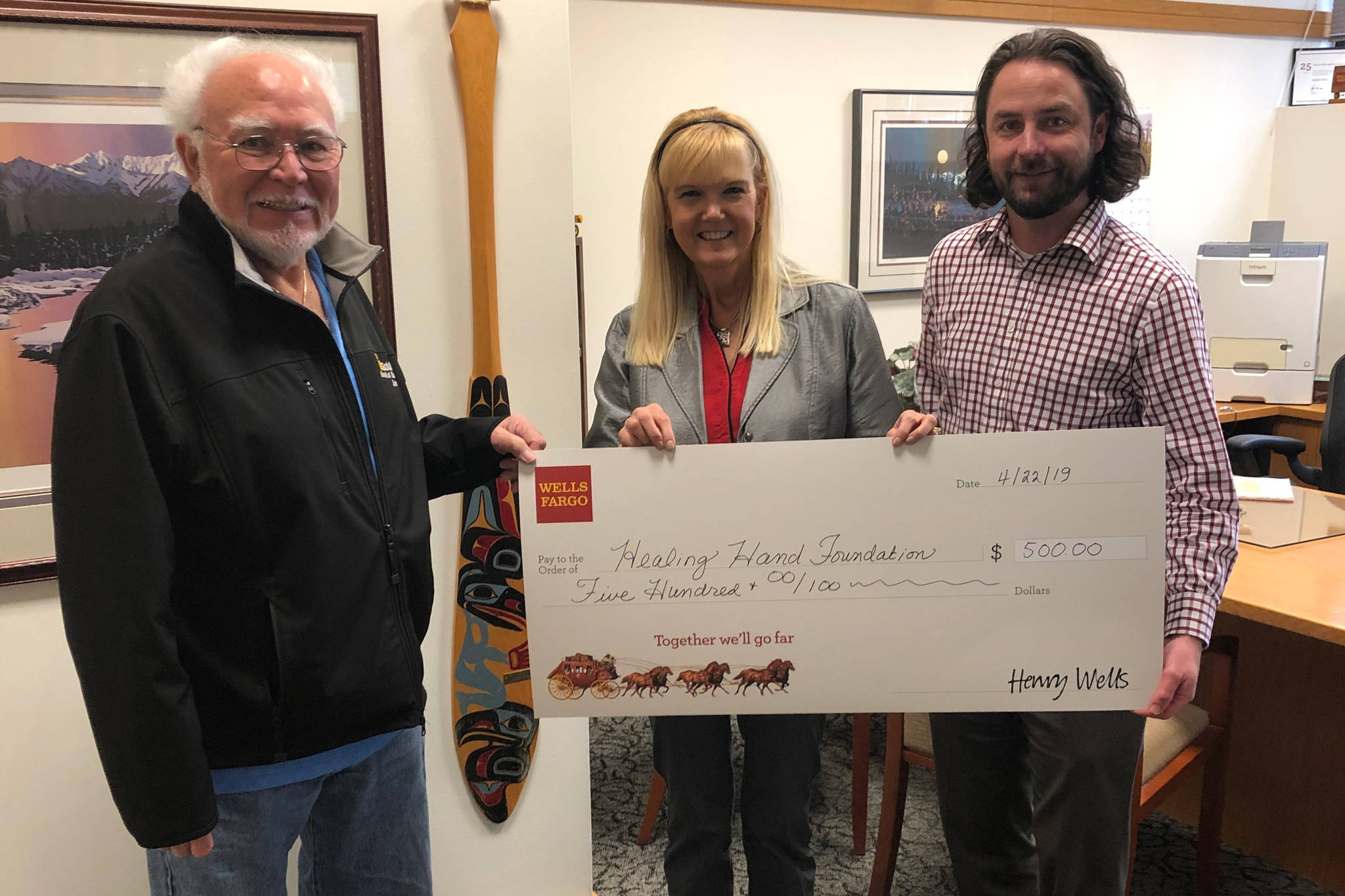 The Healing Hand Foundation recently received a $500 donation from Wells Fargo bank. The donation was presented by Karen West, Wells Fargo vice president, center, and Patrick Ryland, senior business relationship manager, right, to Joe Kahklen, left, board president of the Healing Hand Foundation. (Courtesy Photo)