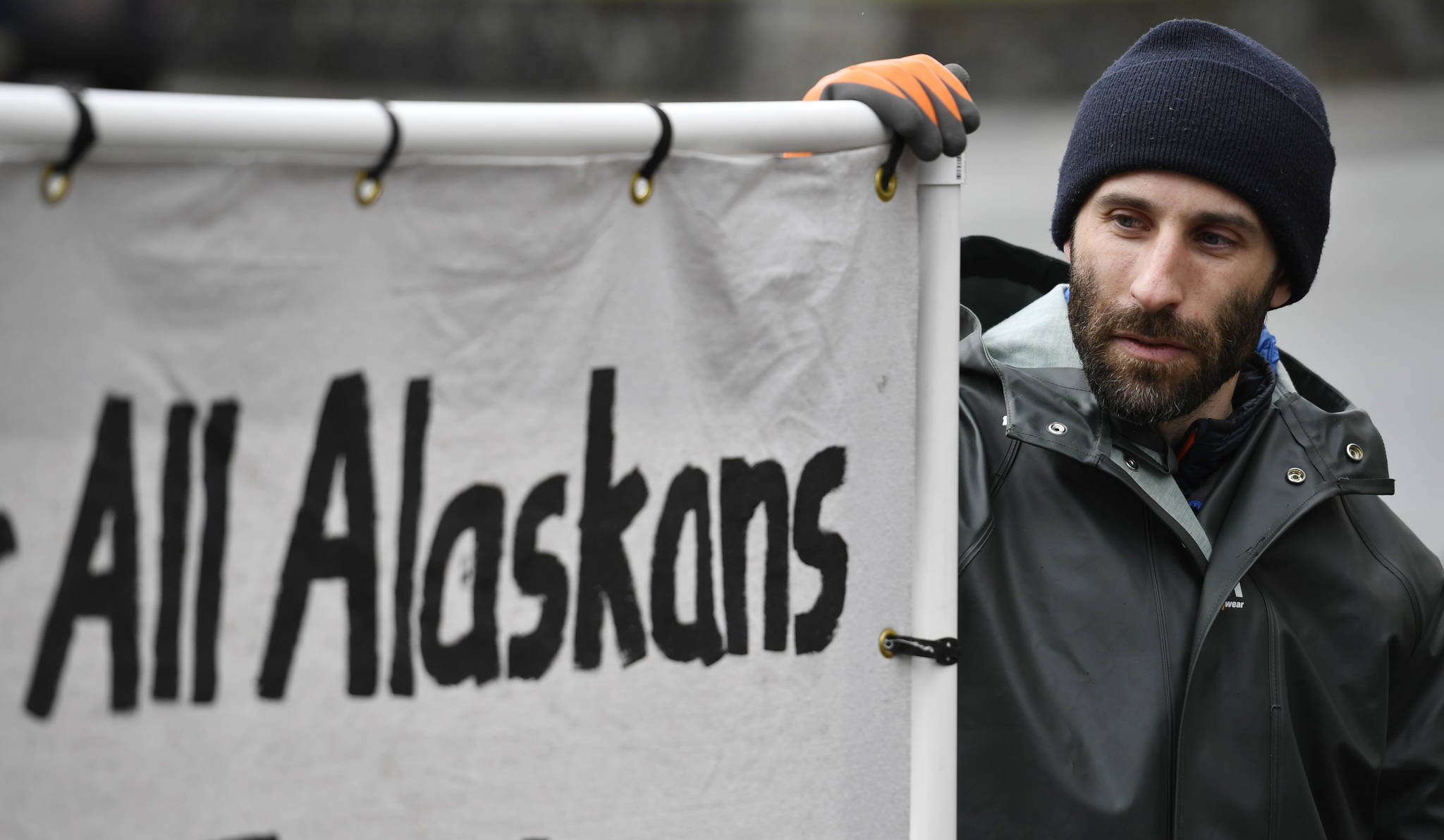 Dan DeSloover holds up his protest sign across from the Capitol on Friday, April 19, 2019. (Michael Penn | Juneau Empire)
