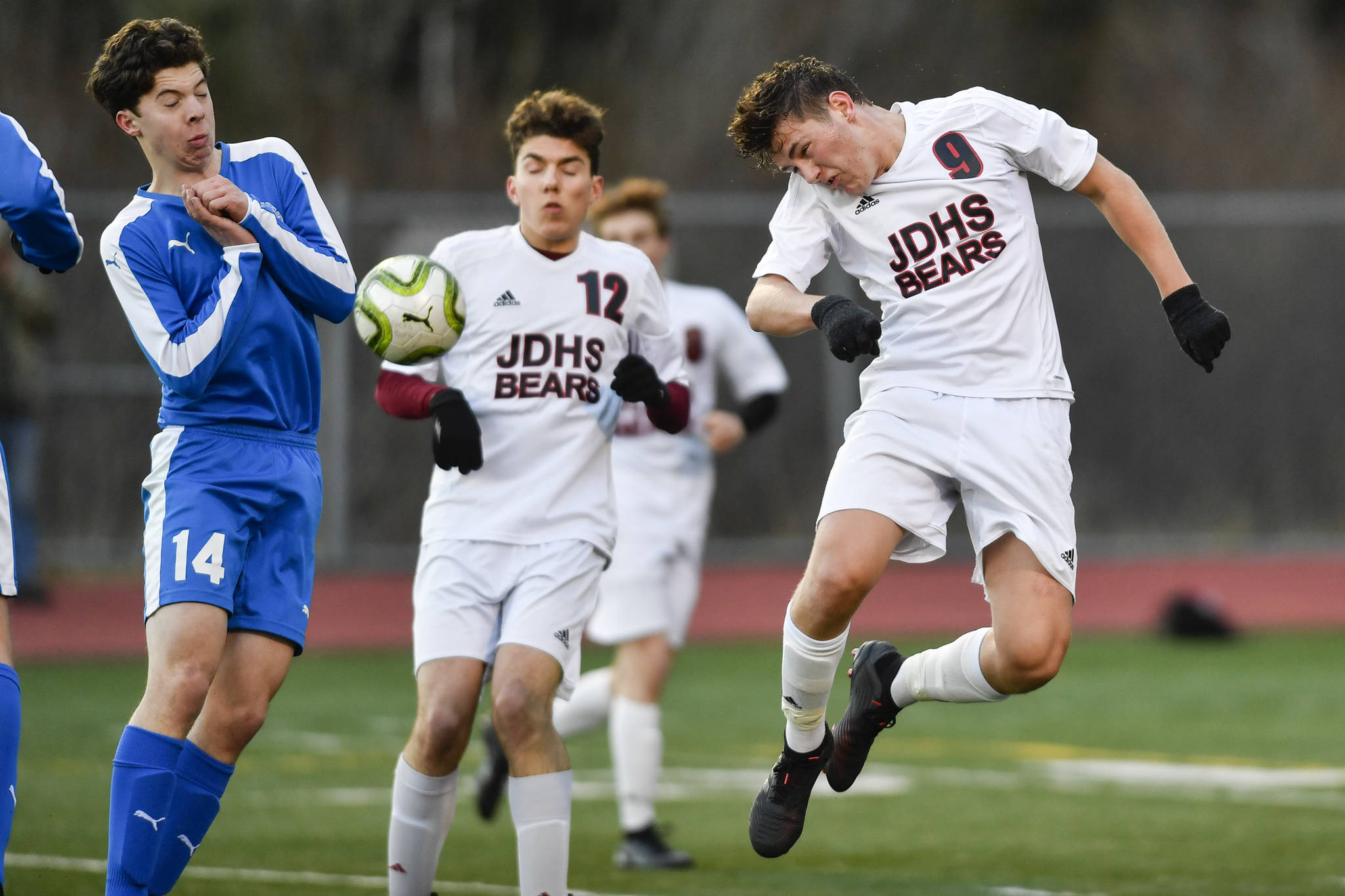 Juneau-Douglas Richard Lehner, right, heads a shot against Thunder Mountains Jake Babcock during their game at TMHS on Tuesday, April 23, 2019. JDHS won 2-0. (Michael Penn | Juneau Empire)
