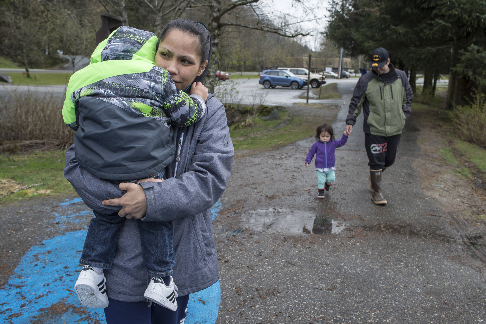 Mary and Steve Littlefield walk to the playground with their children on Wednesday, April 24, 2019. (Michael Penn | Juneau Empire)