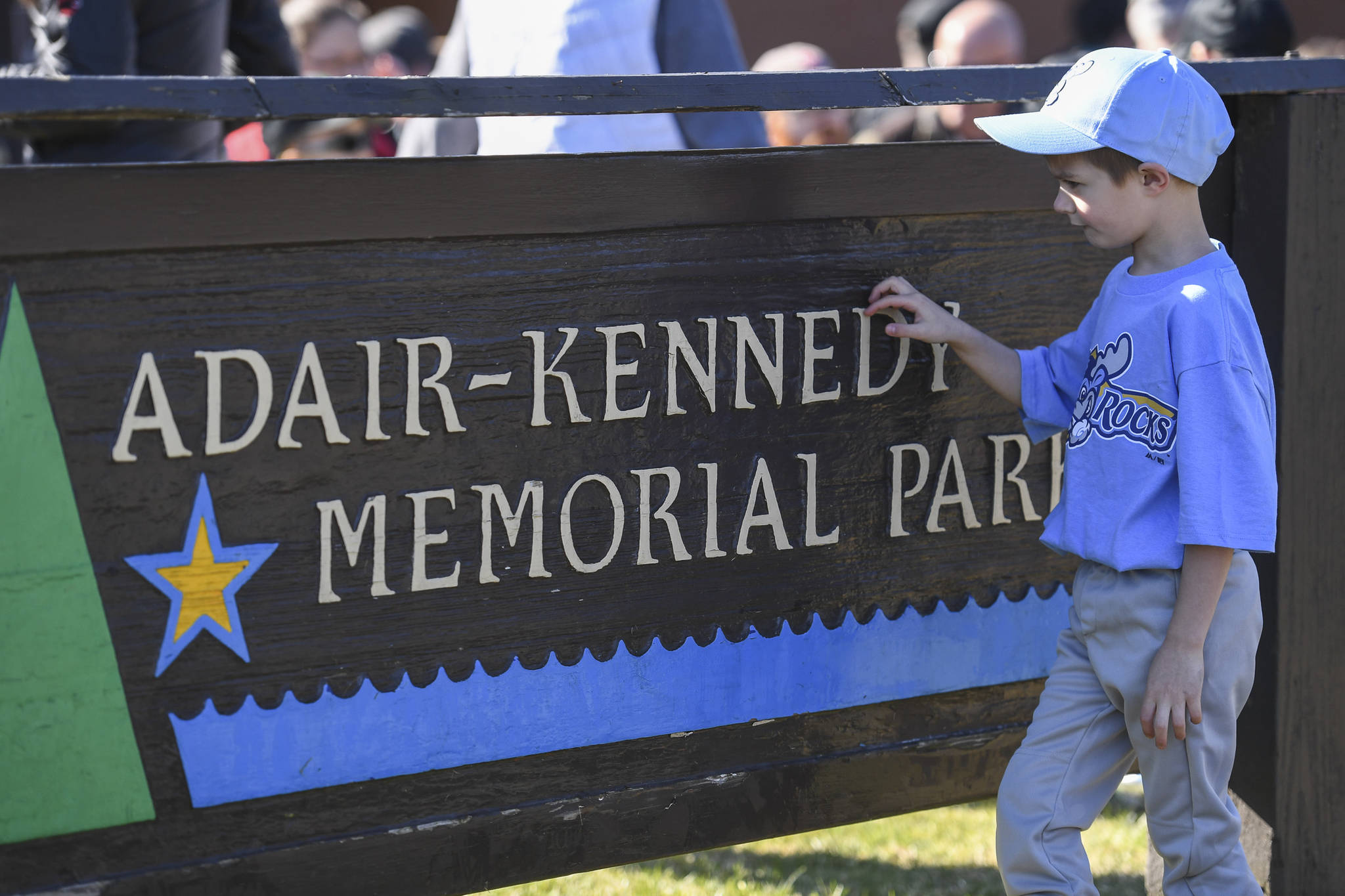 T-ball player Max Pardee, 6, investigates the Adair-Kennedy Memorial Park sign before the Gastineau Channel Little League Opening Day Ceremonies on Saturday, April 27, 2019. (Michael Penn | Juneau Empire)