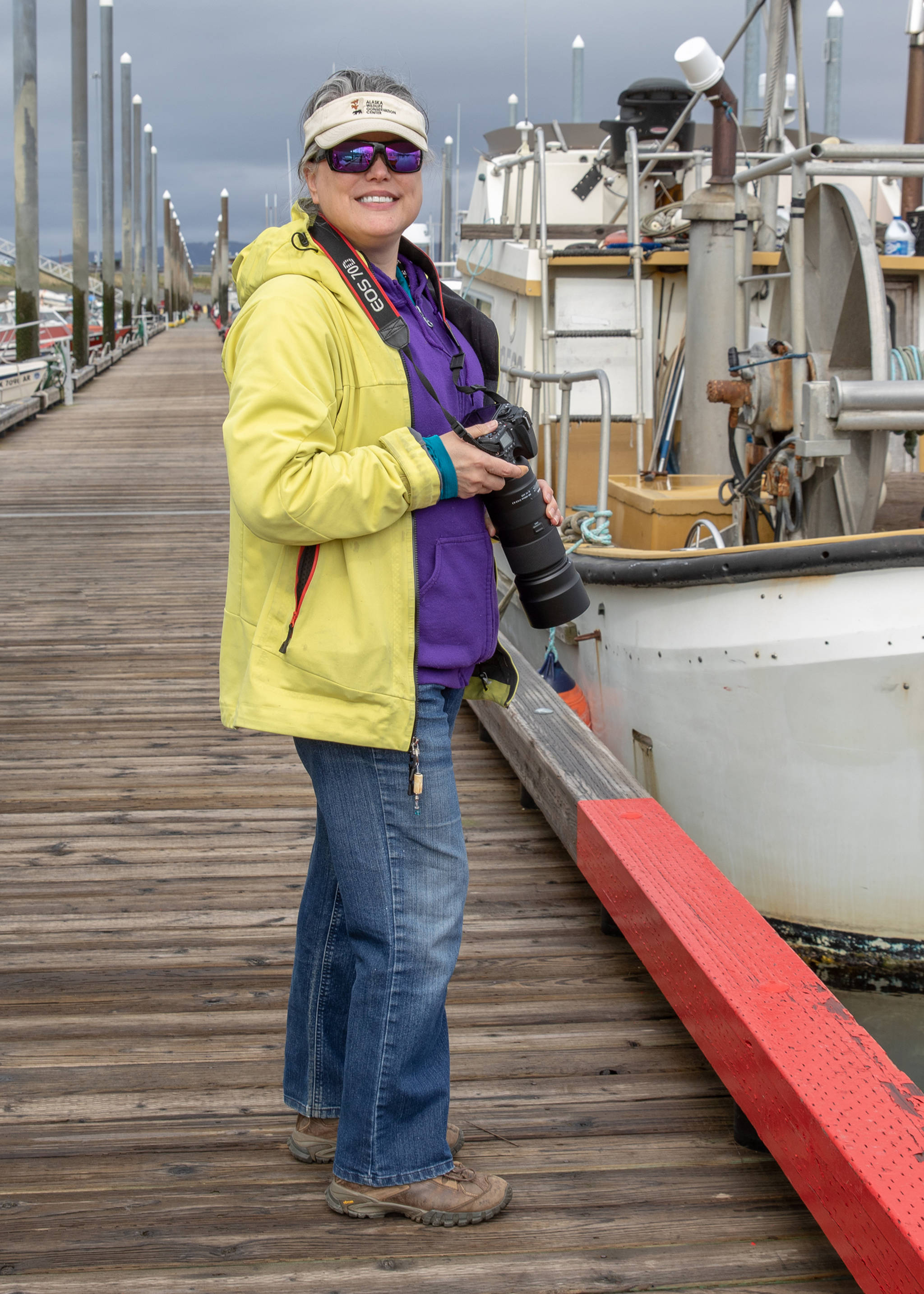 Kristin K’eit proves that you can still look colorful and well-dressed, even when going birding on a blustery day. Her colorful outfit includes a neon yellow waterproof shell by Oakley, purple sweatshirt, jeans and waterproof trail shoes by Vasque.