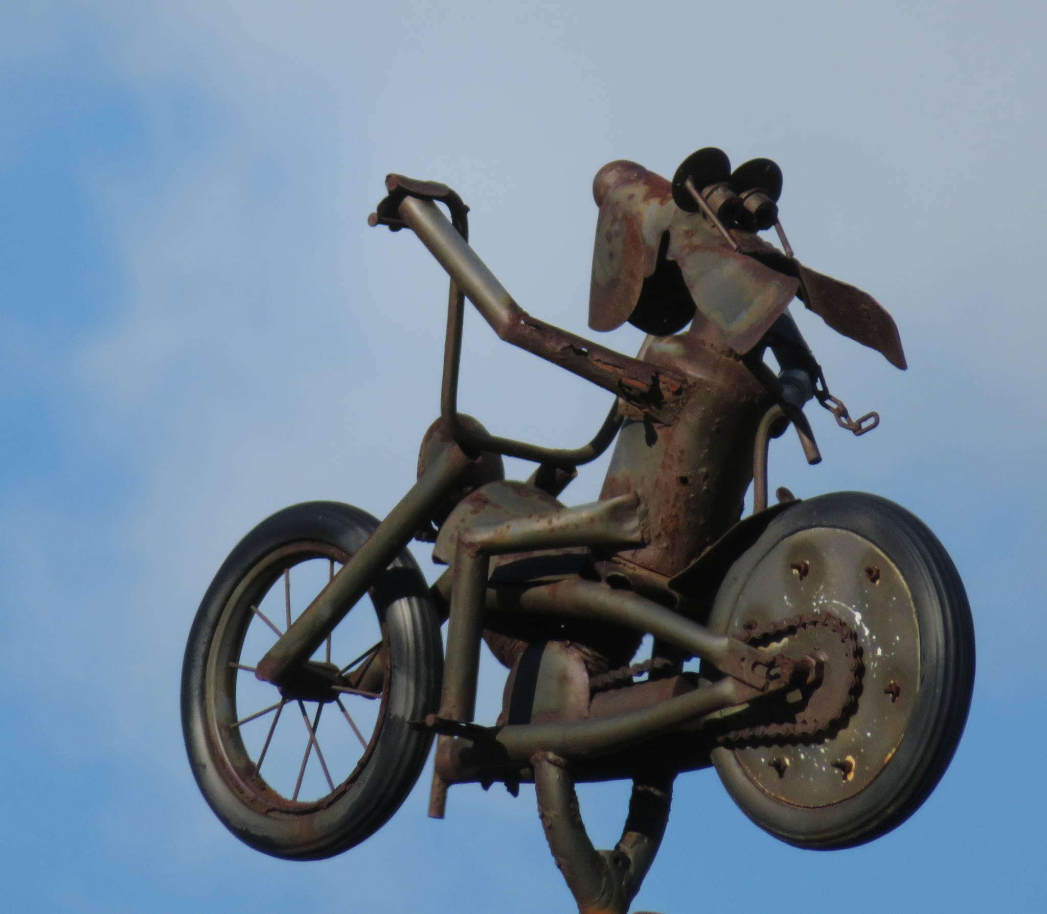 A tin sculpture of a bicyclist cruising above a house in Skagway on May 12, 2019. (Courtesy Photo | Ray Tsang)