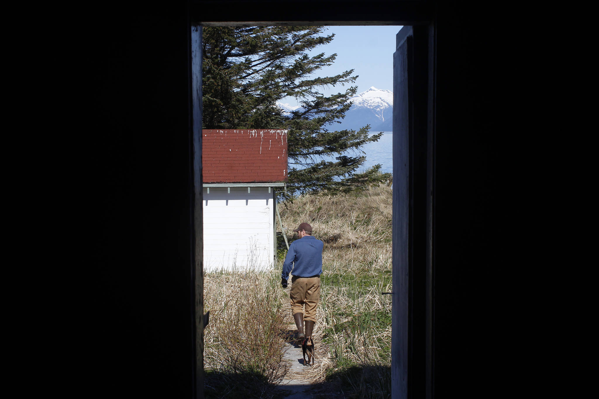 Jonathan Wood, the Marine Exchange of Alaska’s representative on the Eldred Rock Lighthouse Preservation Association, walks out of Eldred Rock Lighthouse on Monday, April 29, 2019. (Alex McCarthy | Juneau Empire)