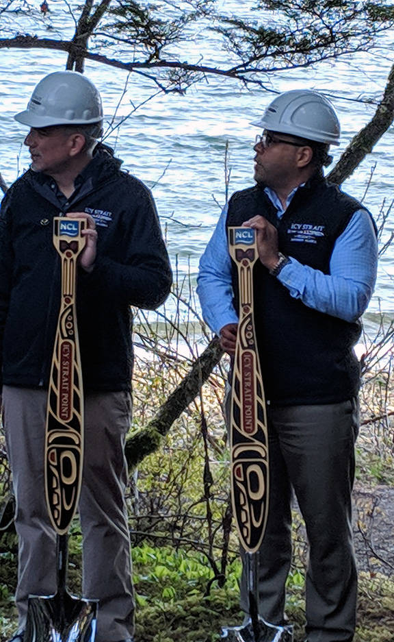 Norwegian Cruise Line Executive Vice President Howard Sherman and Huna Totem Corporation Russell Dick hold paddle-influenced shovels during a ground breaking for a new dock at Icy Strait Point, May 1, 2019. (Ben Hohenstatt | Juneau Empire)