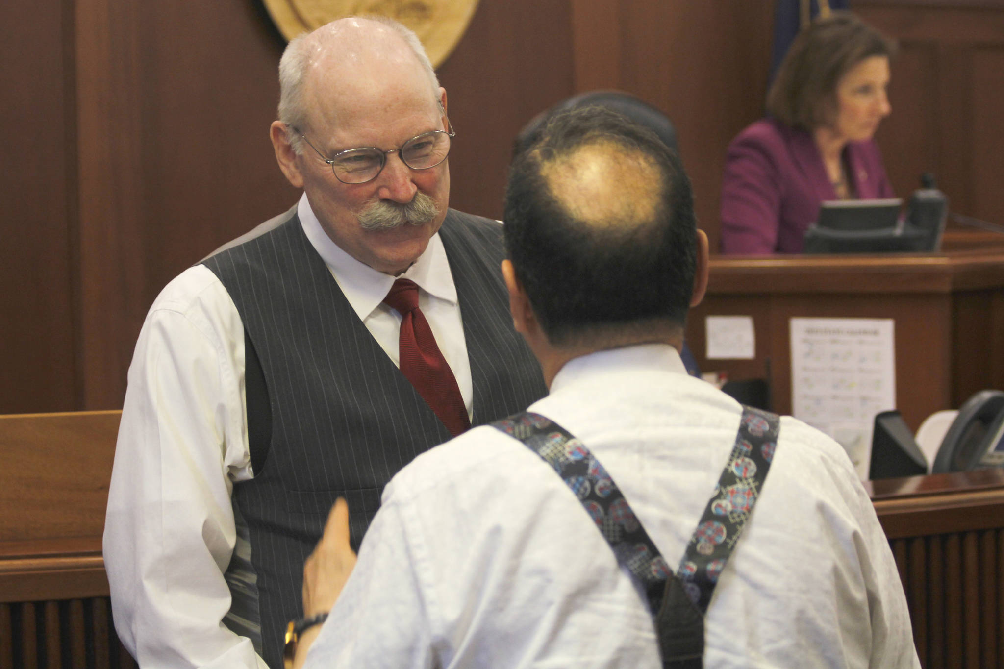 Sen. Bert Stedman, R-Sitka, left, speaks with Sen. Donny Olson, D-Golovin, on the Senate floor at the Alaska State Capitol on Wednesday, May 1, 2019. Senate President Cathy Giessel is pictured in the background. (Alex McCarthy | Juneau Empire)