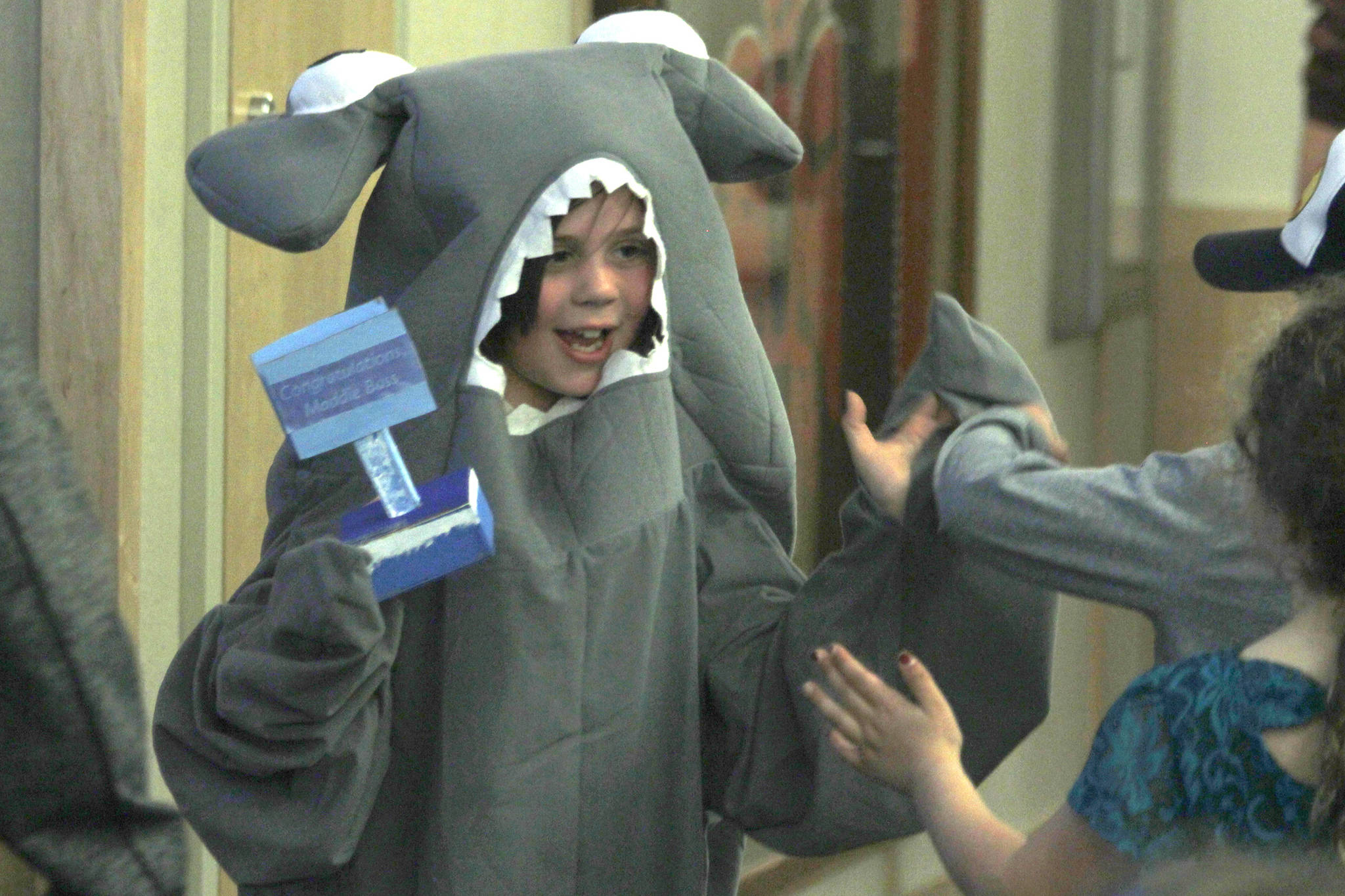Sayeik Gastineau Elementary student Maddie Bass, dressed as a hammerhead shark, gives high-fives to other students after an assembly at the school on Thursday, May 2, 2019. The assembly was a year-end celebration for the Ocean Guardians program that promotes recycling and cutting down on plastic usage. (Alex McCarthy | Juneau Empire)
