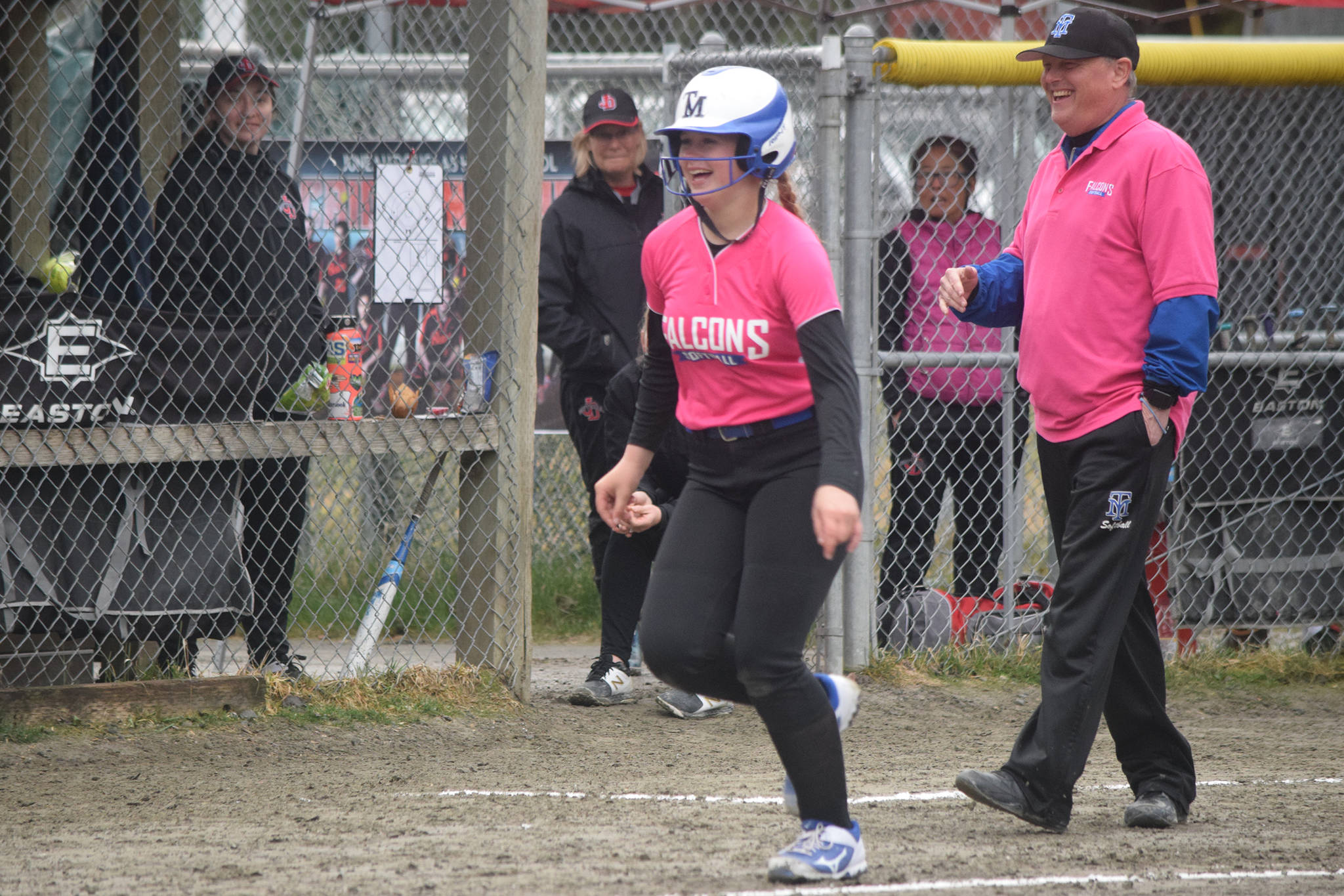 Thunder Mountain High School freshman Sydney Strong runs past coach John Boucher and toward her teammates assembled at home plate after hitting a home run in the first inning of a Southeast Conference softball game at Melvin Park on Friday, May 3, 2019. (Nolin Ainsworth | Juneau Empire)