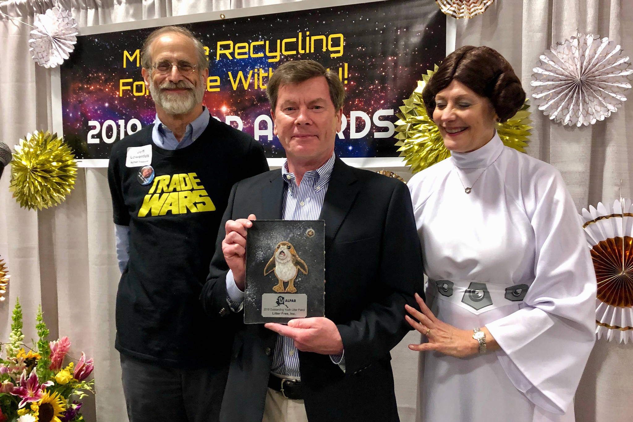 John Logan, center, of Juneaus Litter Free, Inc., holds the 2018 Outstanding Youth Litter Patrol award. (Courtesy Photo)