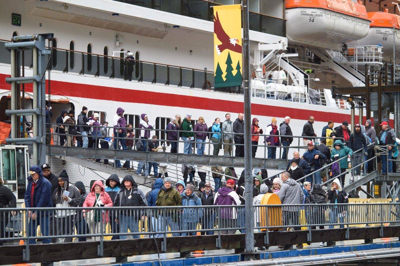 Passengers disembark from the cruise ship Carnival Legend at the South Franklin Dock on Wednesday, May 8, 2019. The company was cited for excess air pollution last year. (Michael Penn | Juneau Empire)