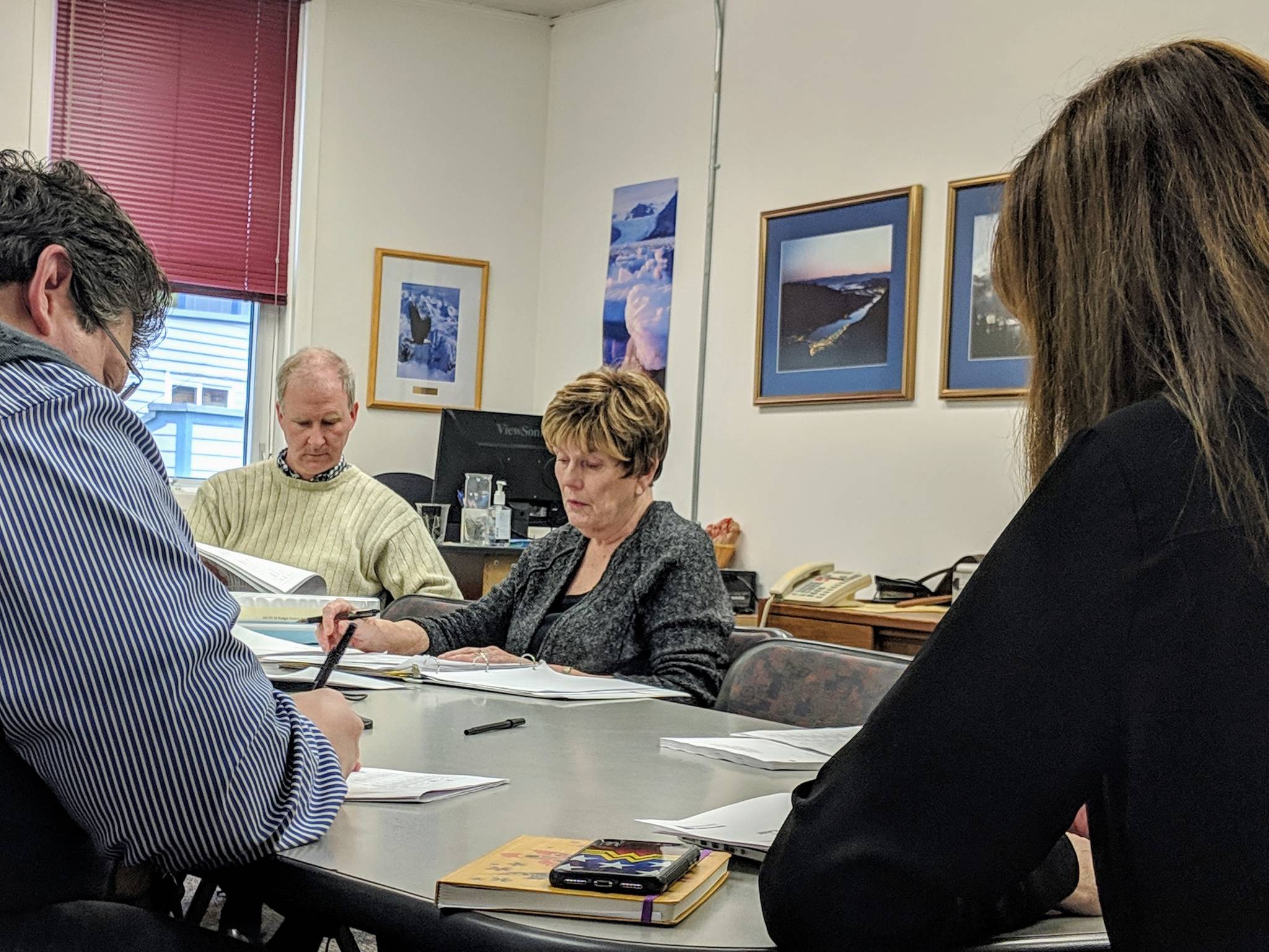 City and Borough of Juneau and Juneau School District Joint Facilities Committee members review findings about space for child care programs in Juneau Schools. (Ben Hohenstatt | Juneau Empire)