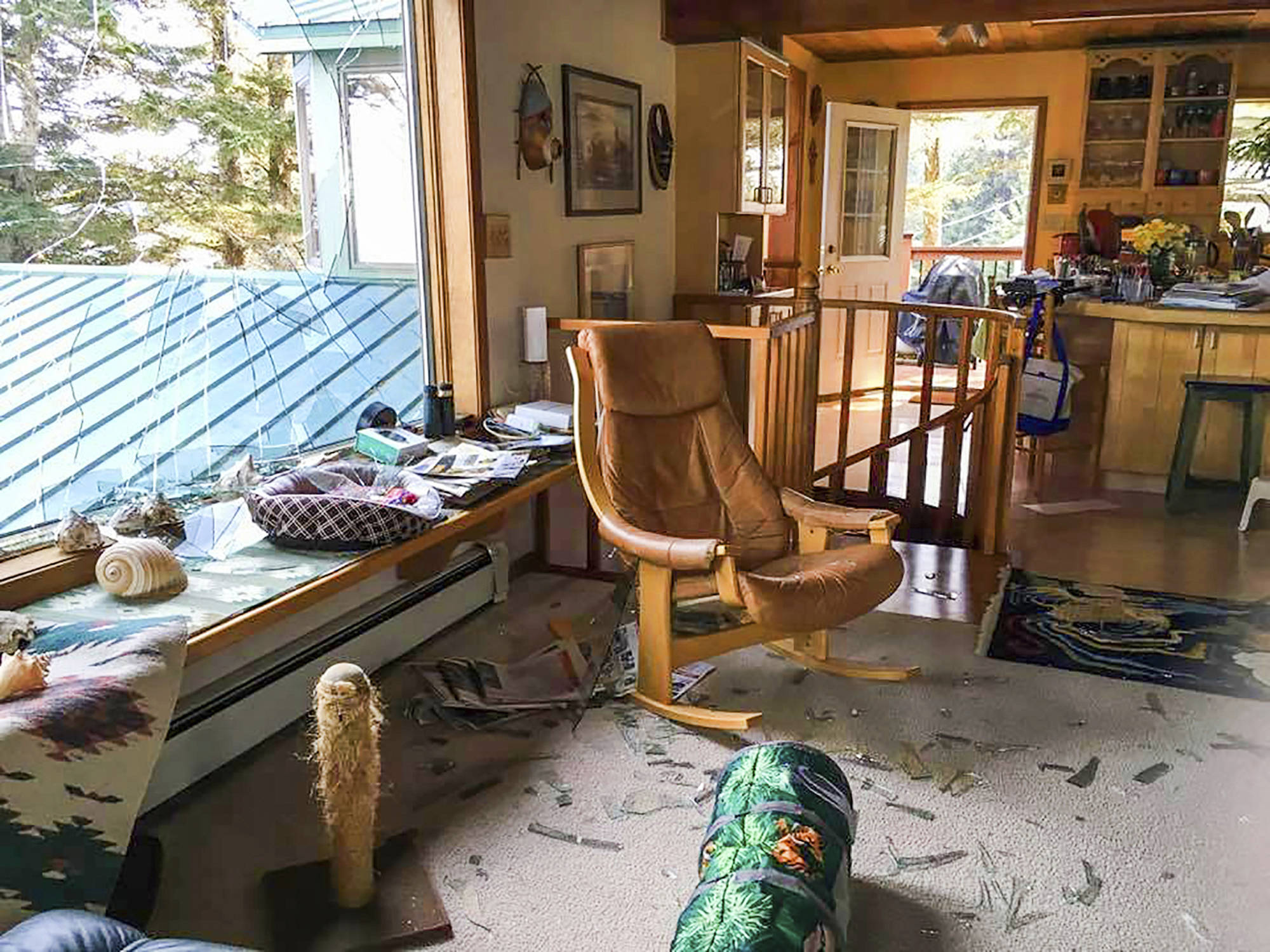 This May 4, 2019 photo shows extensive damage in the living room area of Stacy Studebaker’s home in Kodiak, Alaska, after an eagle flew through a large window. (Stacy Studebaker)