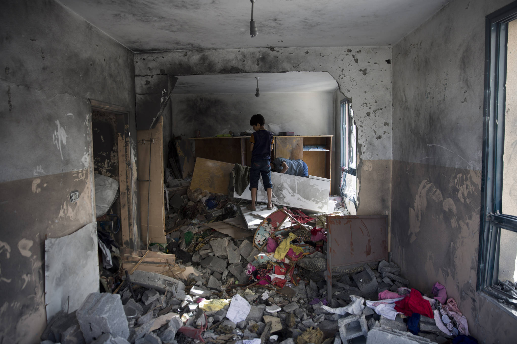 Palestinians inspect a damaged bedroom following a late night Israeli missile strike on a building in town of Beit Lahiya, Northern Gaza Strip on Monday, May, 6, 2019. The Israeli military has lifted protective restrictions on residents in southern Israel while Gaza’s ruling Hamas militant group reported a cease-fire deal had been reached to end the deadliest fighting between the two sides since a 2014 war. (Khalil Hamra | Associated Press)