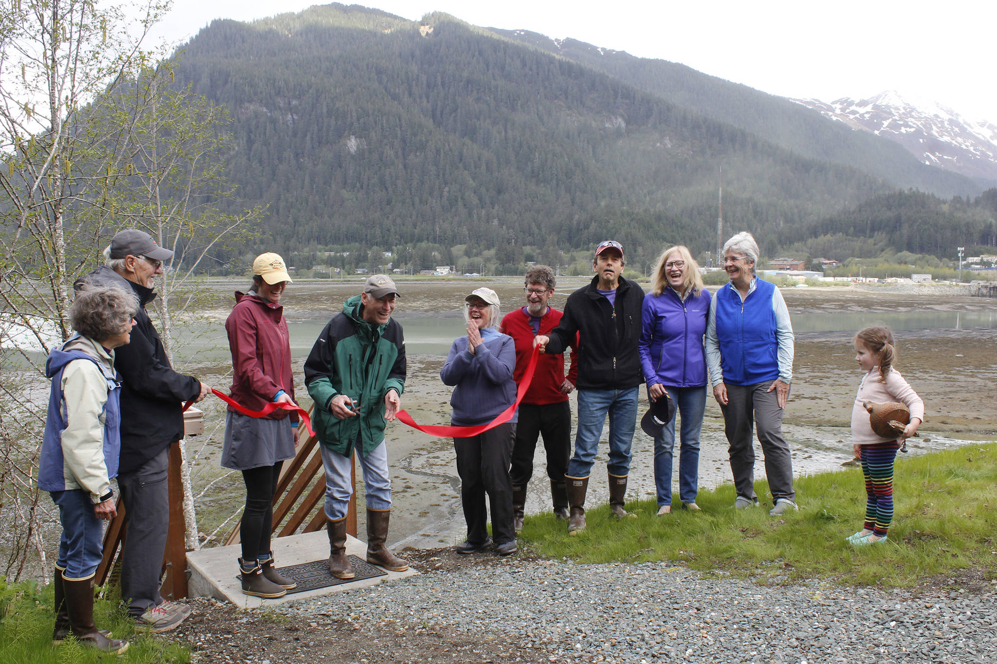 Donors and members of the Southeast Alaska Land Trust board cut a ceremonial ribbon to celebrate the opening of the Marjory and Edgar Huizer Fishing Access Site on Saturday, May 11, 2019. (Alex McCarthy | Juneau Empire)