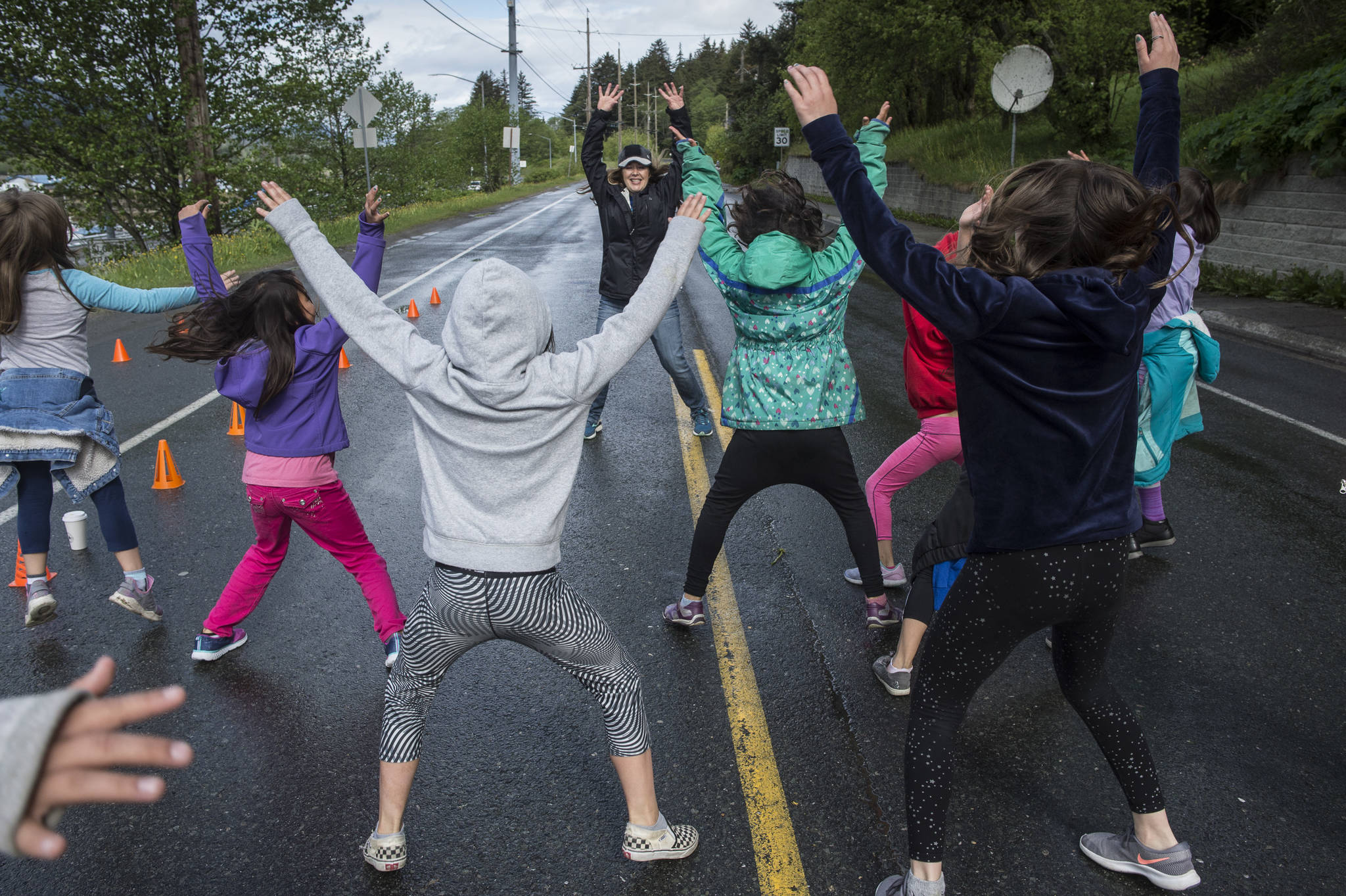 Physical Education Teacher Nikki Richert warms students up before Harborview Elementary School’s annual Fun Run along Glacier Avenue on Friday, May 17, 2019. Students from Montessori Borealis also ran the three-mile course. (Michael Penn | Juneau Empire)