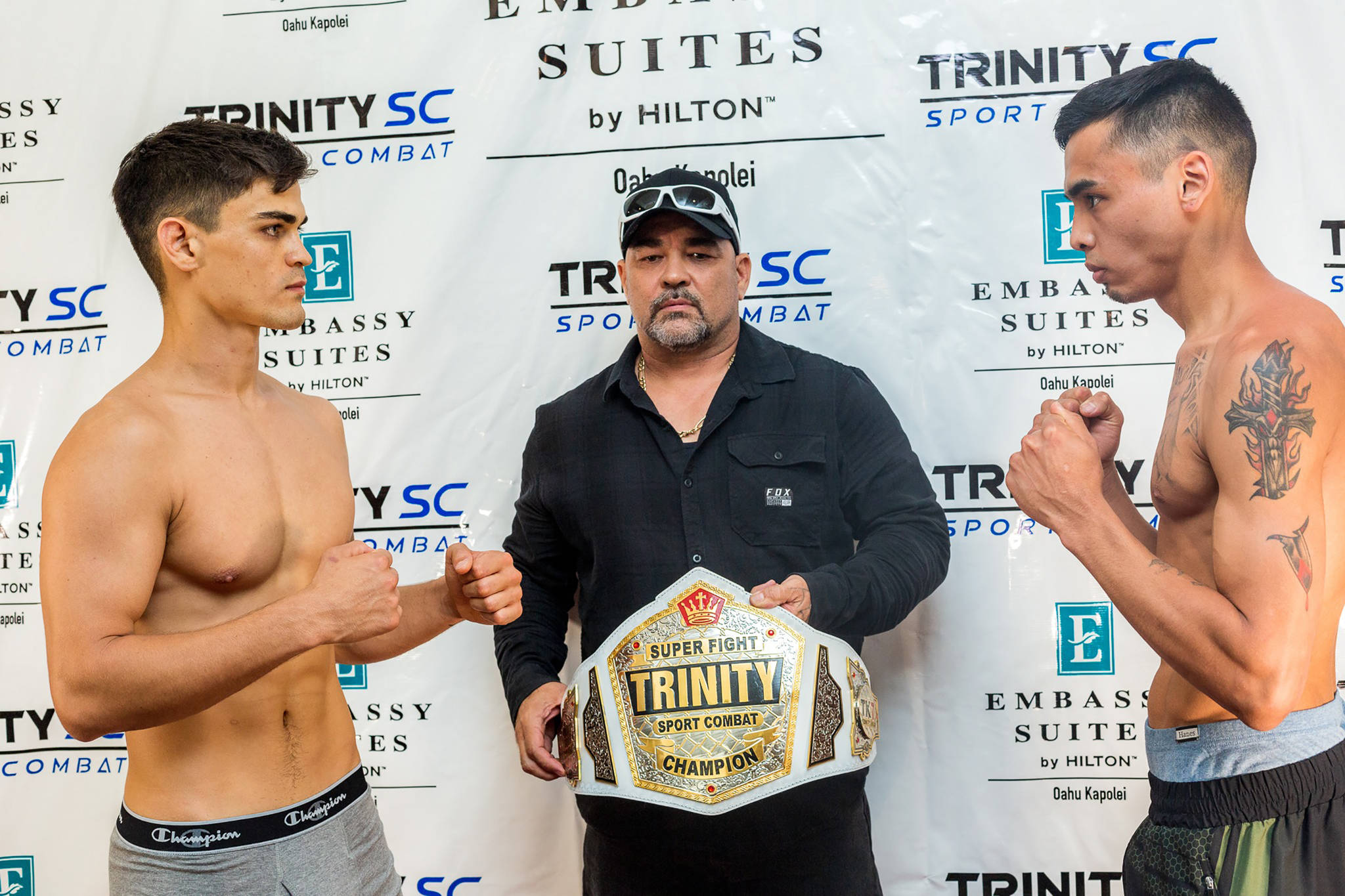 Clifford White, right, and Robby “SuperNatural” Ostovich are shown next to the Trinity Sport Combat 155-pound Super Lightweight Title belt. (Courtesy Photo | Francis Philip Quibilan Photography)