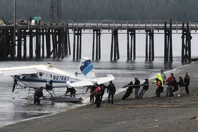 Good Samaritans and emergency responders pull in a floatplane involved in a fatal crash just after 6 p.m. Monday, May 20. (Courtesy Photo | Debra Milton)