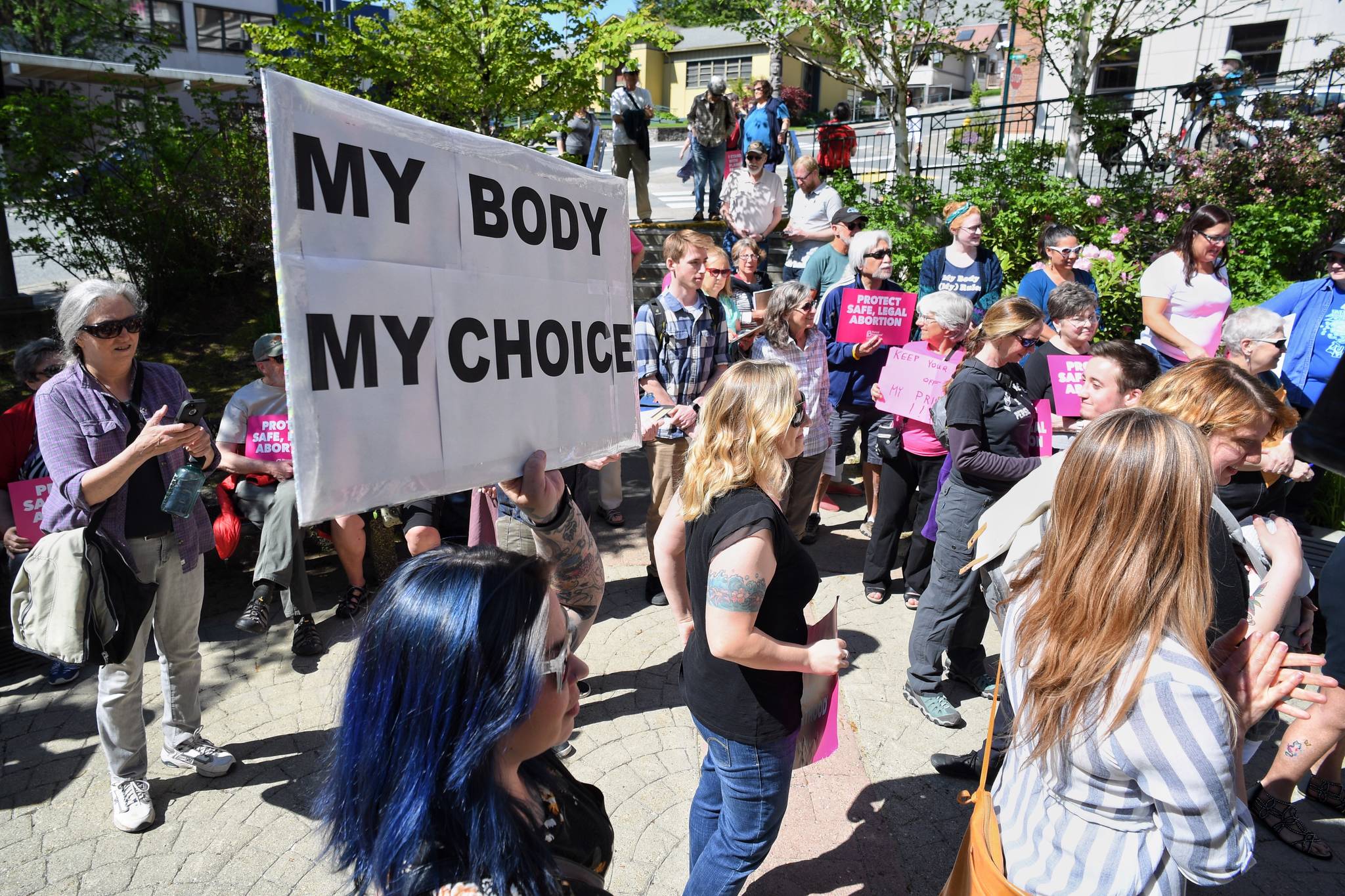 People attend a rally against anti-abortion laws at the Dimond Courthouse Plaza on Tuesday, May 21, 2019. (Michael Penn | Juneau Empire)