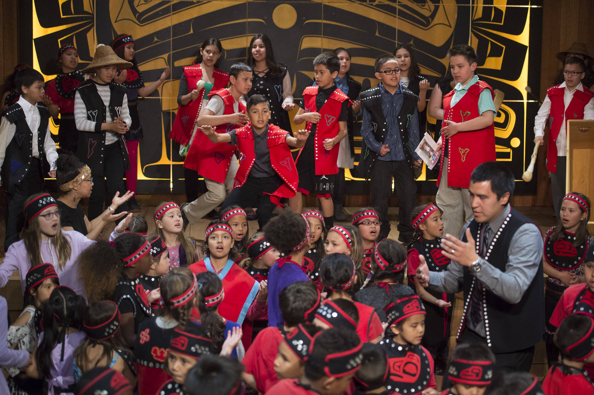 Students with the Tlingit Culture Language & Literacy program at Harborview Elementary School dance during the 5th Grade Promotion ceremony held in the clan house at the Walter Soboleff Center on Wednesday, May 22, 2019. (Michael Penn | Juneau Empire)