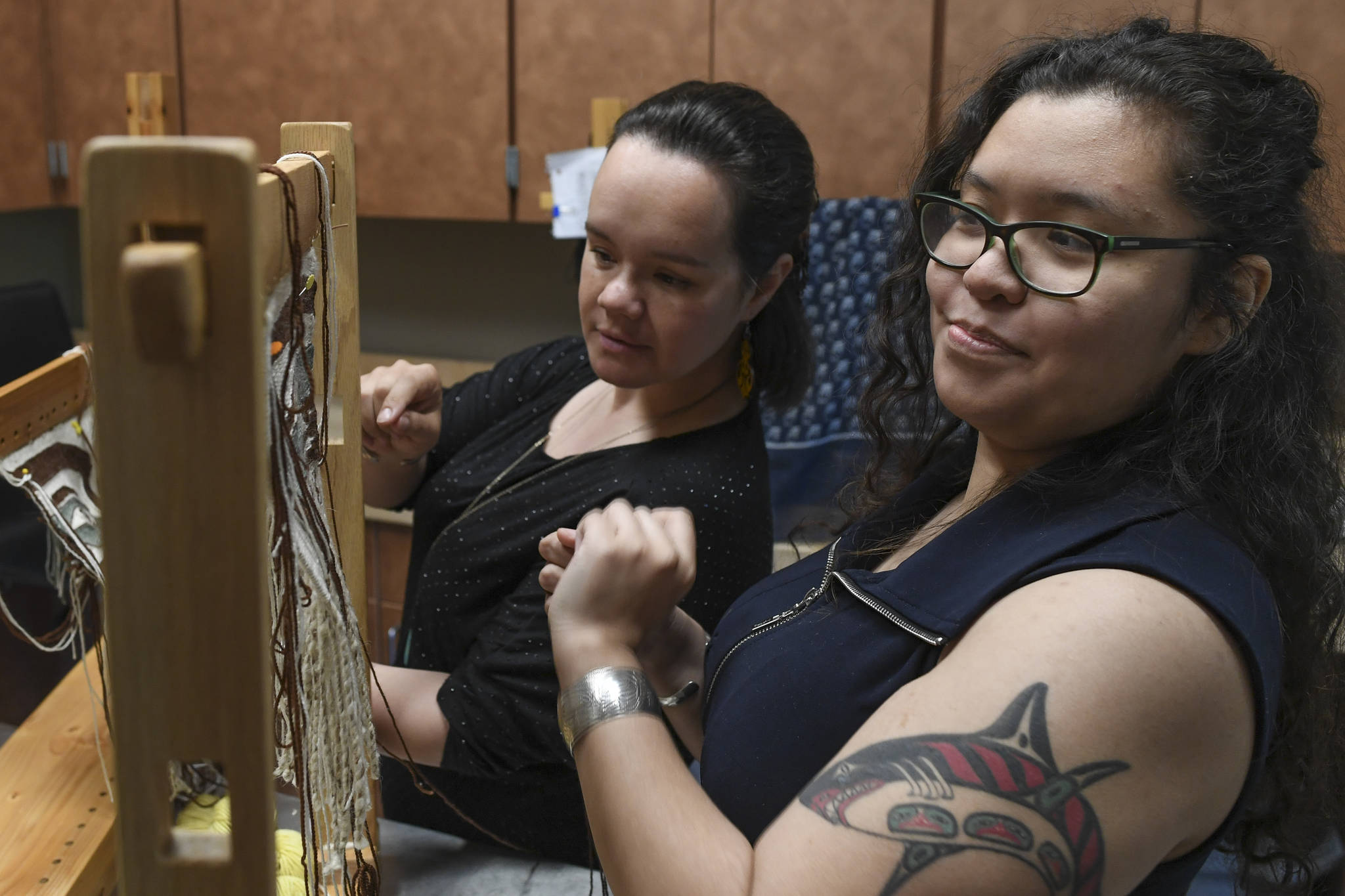 Anastasia Hobson-George, right, works with weaver Lily Hope as the Artist-in-Residence at the Walter Soboleff Center on Wednesday, May 22, 2019. (Michael Penn | Juneau Empire)