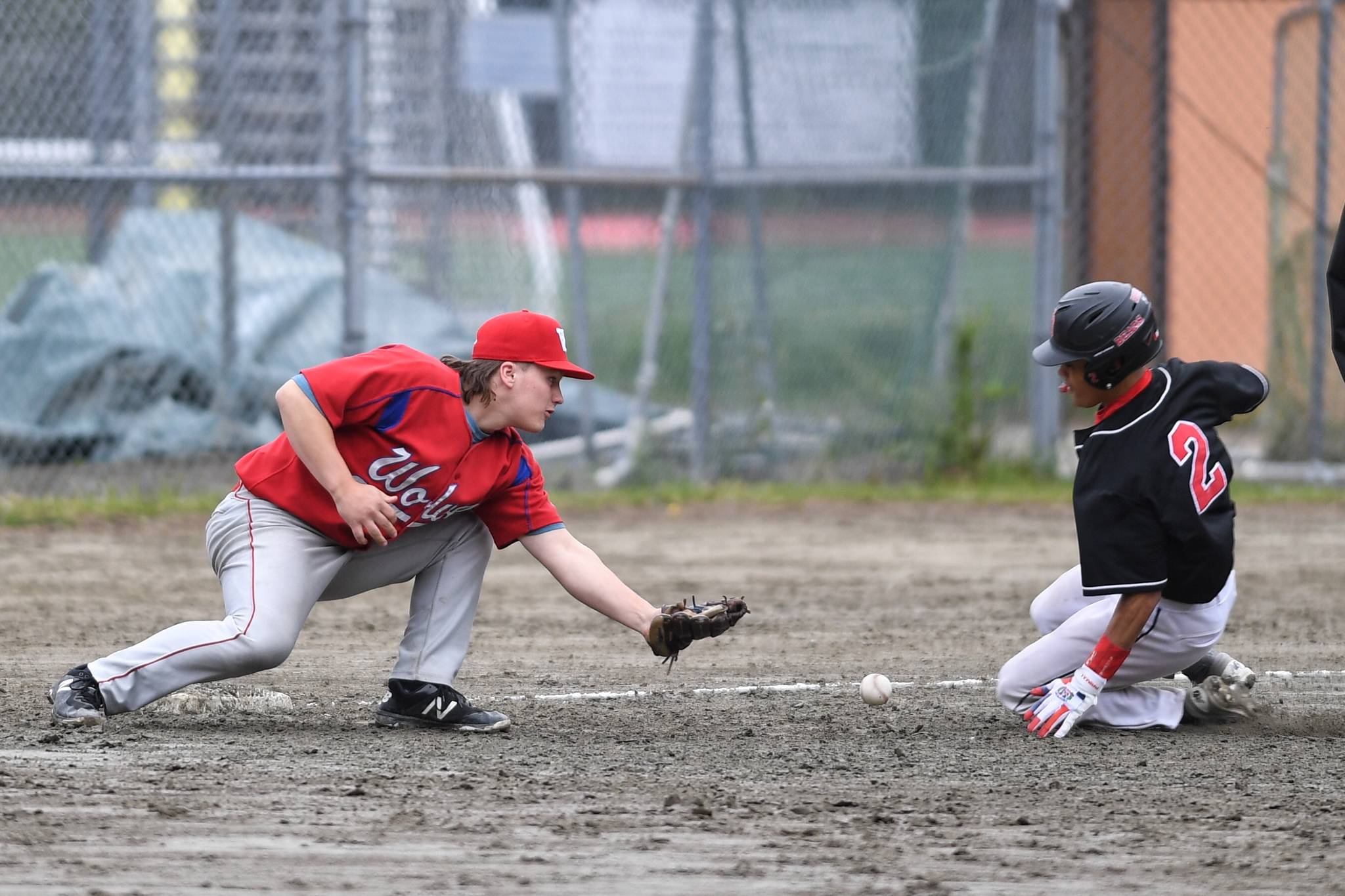 Juneau-Douglas’ Luis Mojica, right, slides safely into third base as Sitka’s Trevin Carley bobbles the throw during the Region V Baseball Championship at Adair-Kennedy Memorial Park on Thursday, May 23, 2019. (Michael Penn | Juneau Empire)