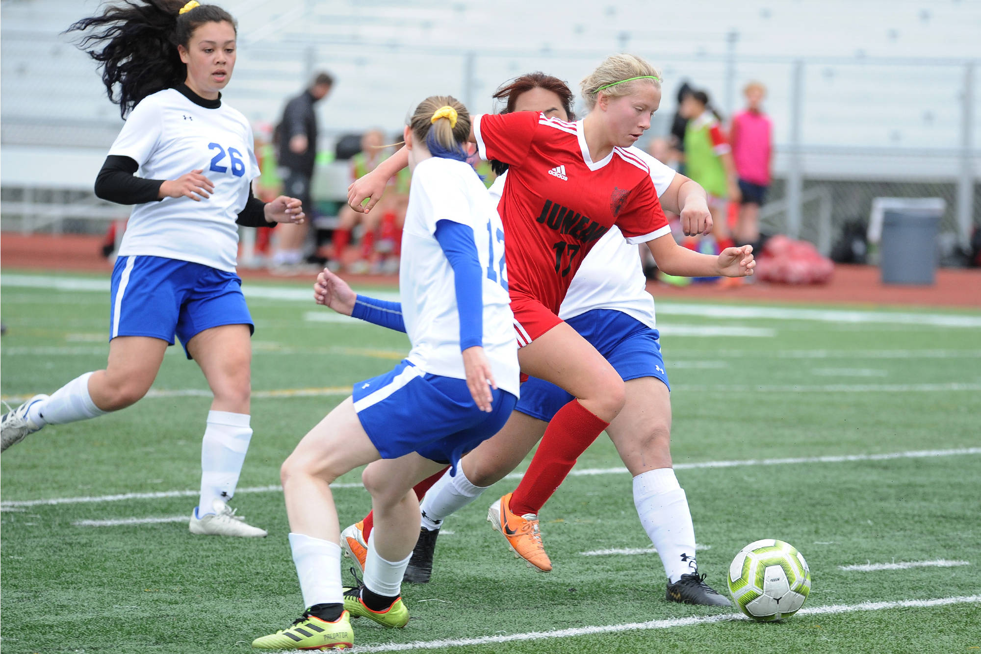 Juneau-Douglas’ Taylor Bentley busts through a trio Kodiak defenders during the ASAA/First National Bank Alaska soccer state championships at Service High School in Anchorage on Thursday, May 23, 2019. (Michael Dinneen | For the Juneau Empire)